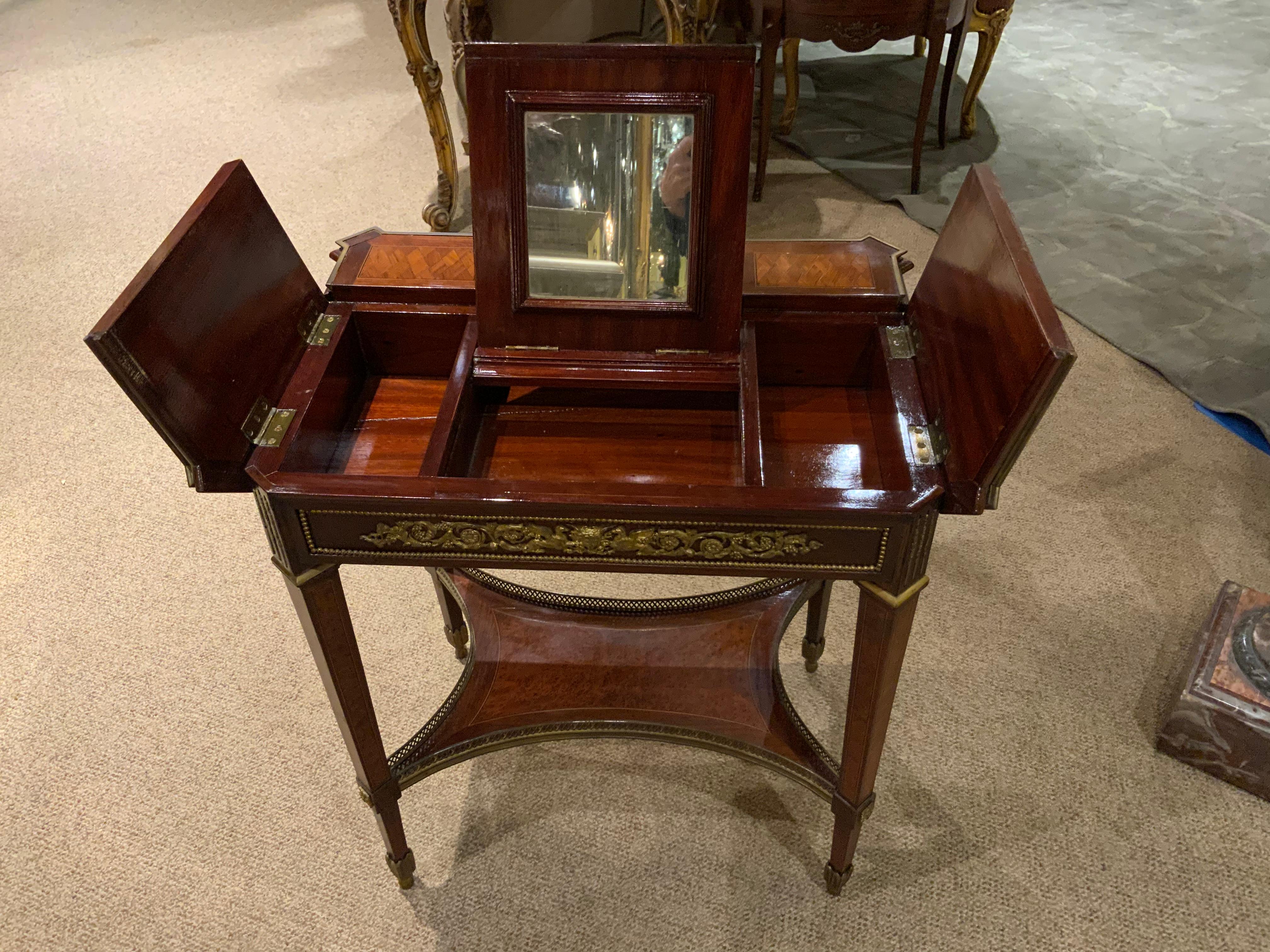 Exquisite table and beautiful workmanship with fine marquetry. The top slides forward to
Open with a mirror inside to use as a vanity. Fine tapered legs and gilt bronze mounts make
This table special.