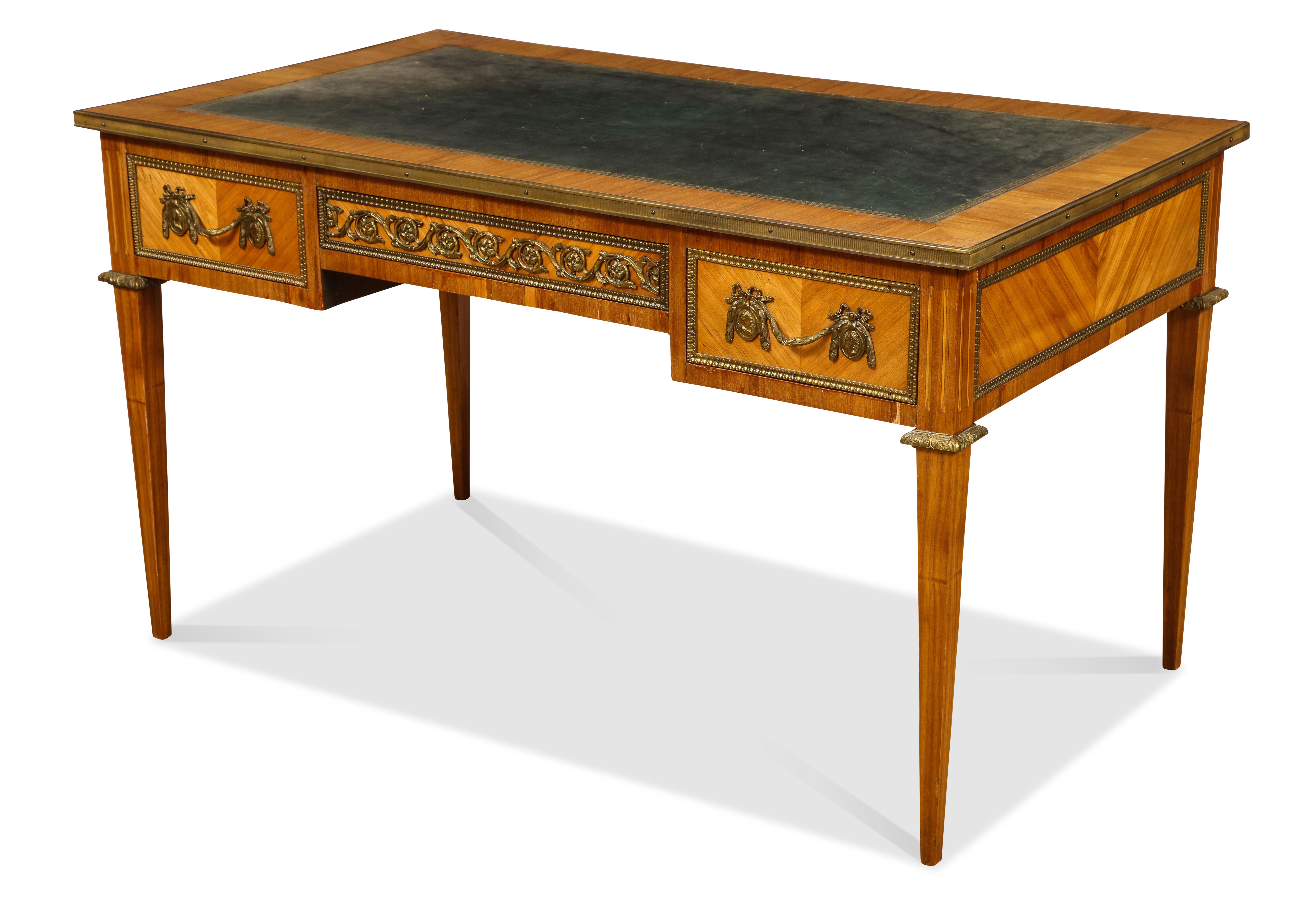 The all-over parquetry veneered fruit-wood desk having 3 drawers on one side and 3 faux drawers on the opposite side. The whole with bronze mounts.
     