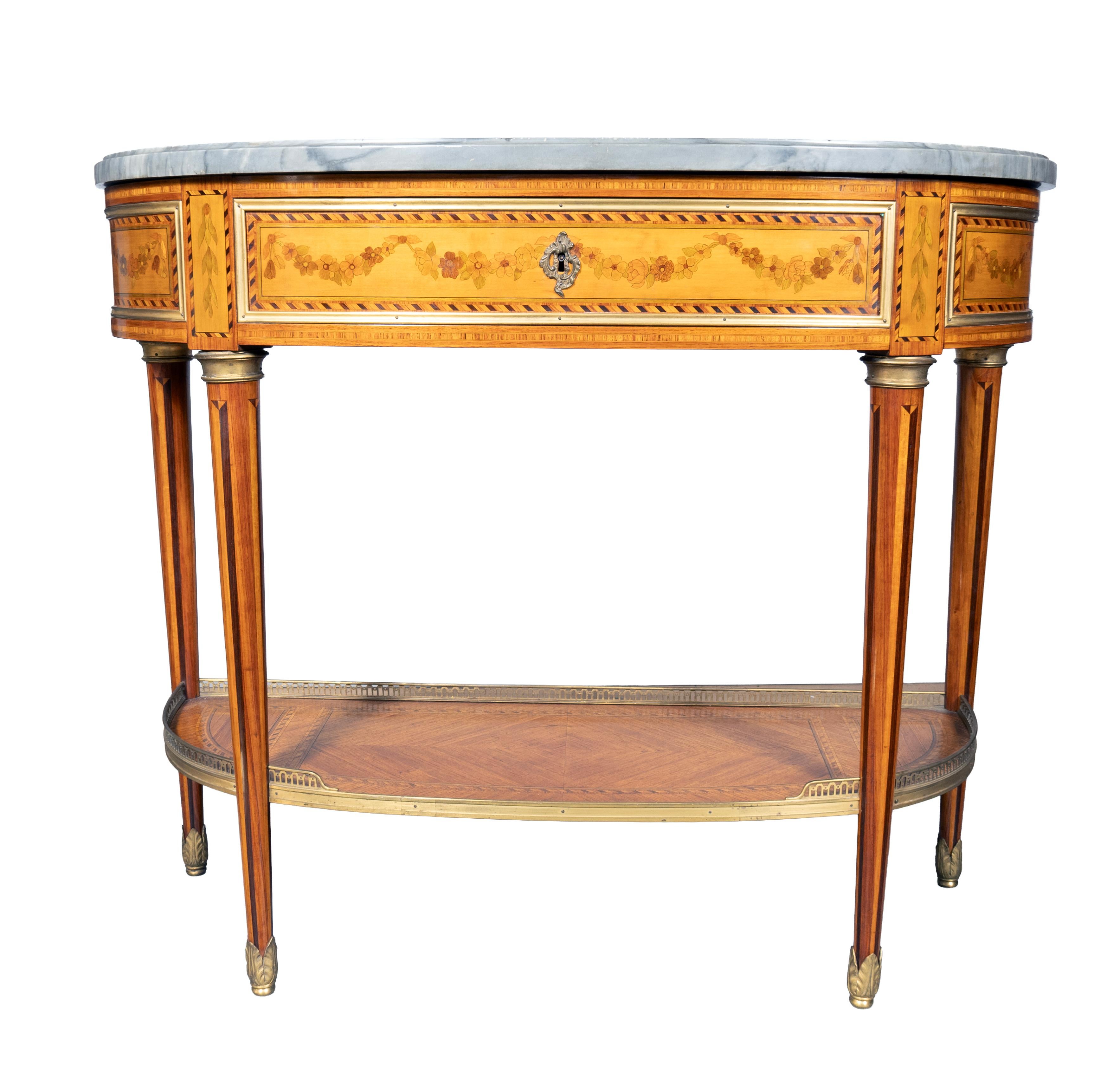 Rectangular blue turquin marble top with rounded ends over a conforming case with a drawer. Circular tapered legs with conforming lower shelf. Ending on sabot feet.