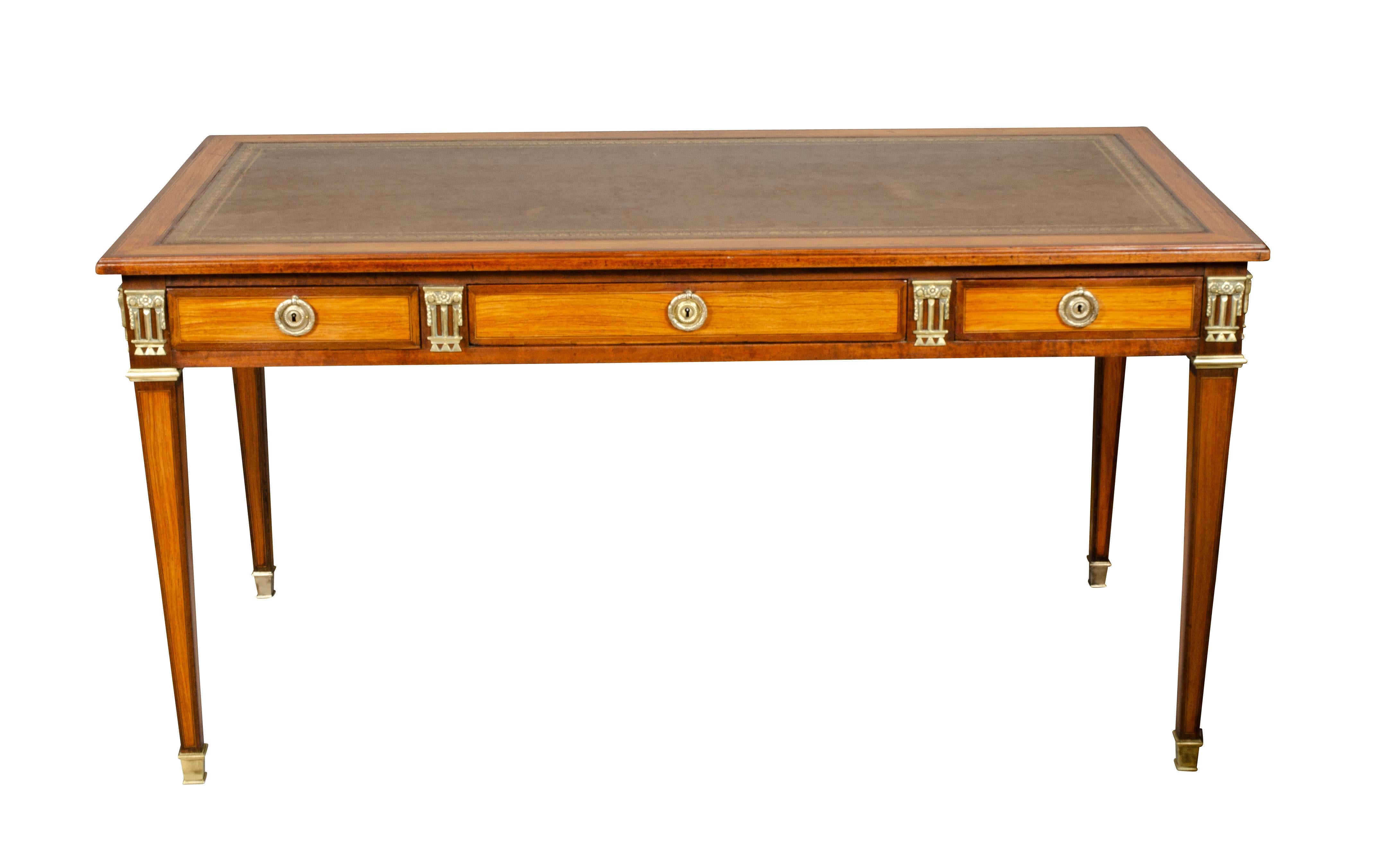 Original to the Waldorf Towers in New York City with metal tag and serial number on back. New tooled brown leather top set within an inlaid border over three drawers with flanking bronze mounts raised on square tapered legs. Back finished so can