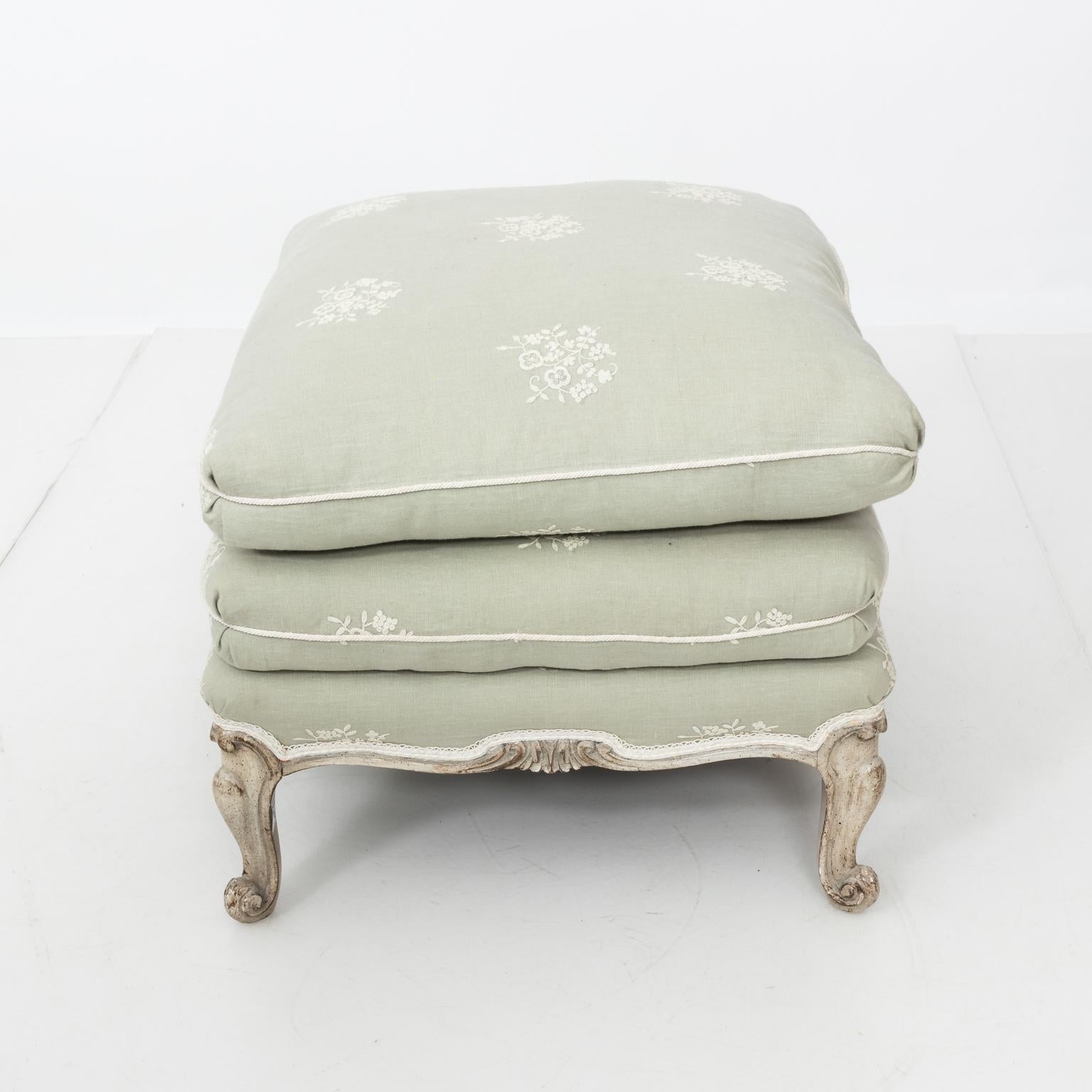 Louis XVI style ottoman with embroided linen upholstery and adorned with cream welt and tape with removable top pillow.
 