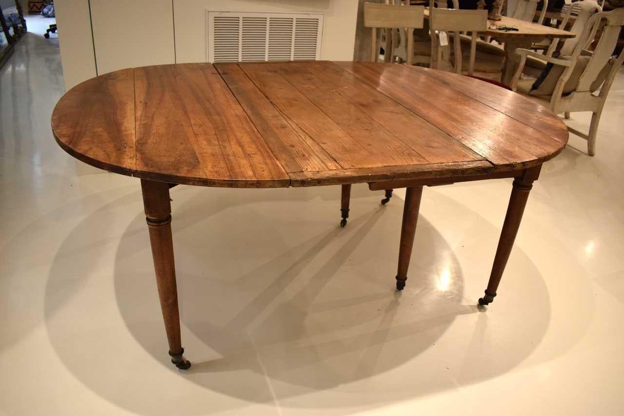 Versatile Louis XVI Style walnut dining table with one leaf. Extra extensions can accommodate additional leaves. Fully extended length is 88