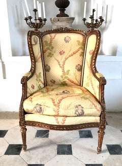 Louis XVI style wingback armchair – 19th century – carved wood & floral fabric