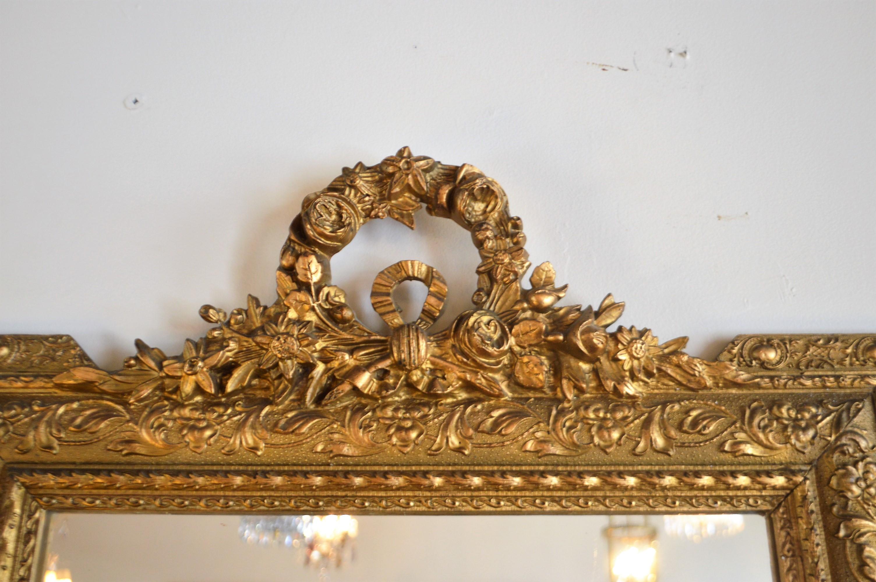 Great proportion on this Louis XVI style gilded mirror, excellent hand-carved details at top, wreath with flowers and acanthus leaves. The entire frame has carved elements.