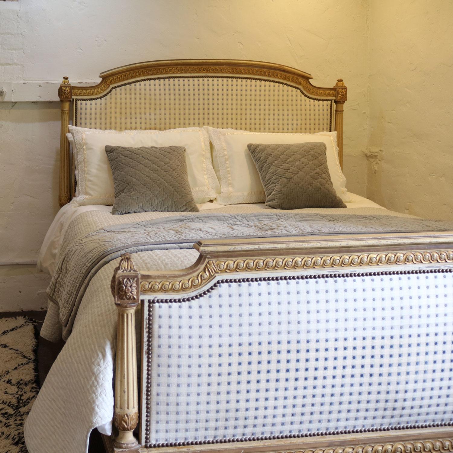 A Louis XVI style bedstead with painted and gilded framework, in its original finish, with upholstered panels. 

The upholstery requires replacing as it does show signs of age and this work will be included in the price. The fabric can be chosen