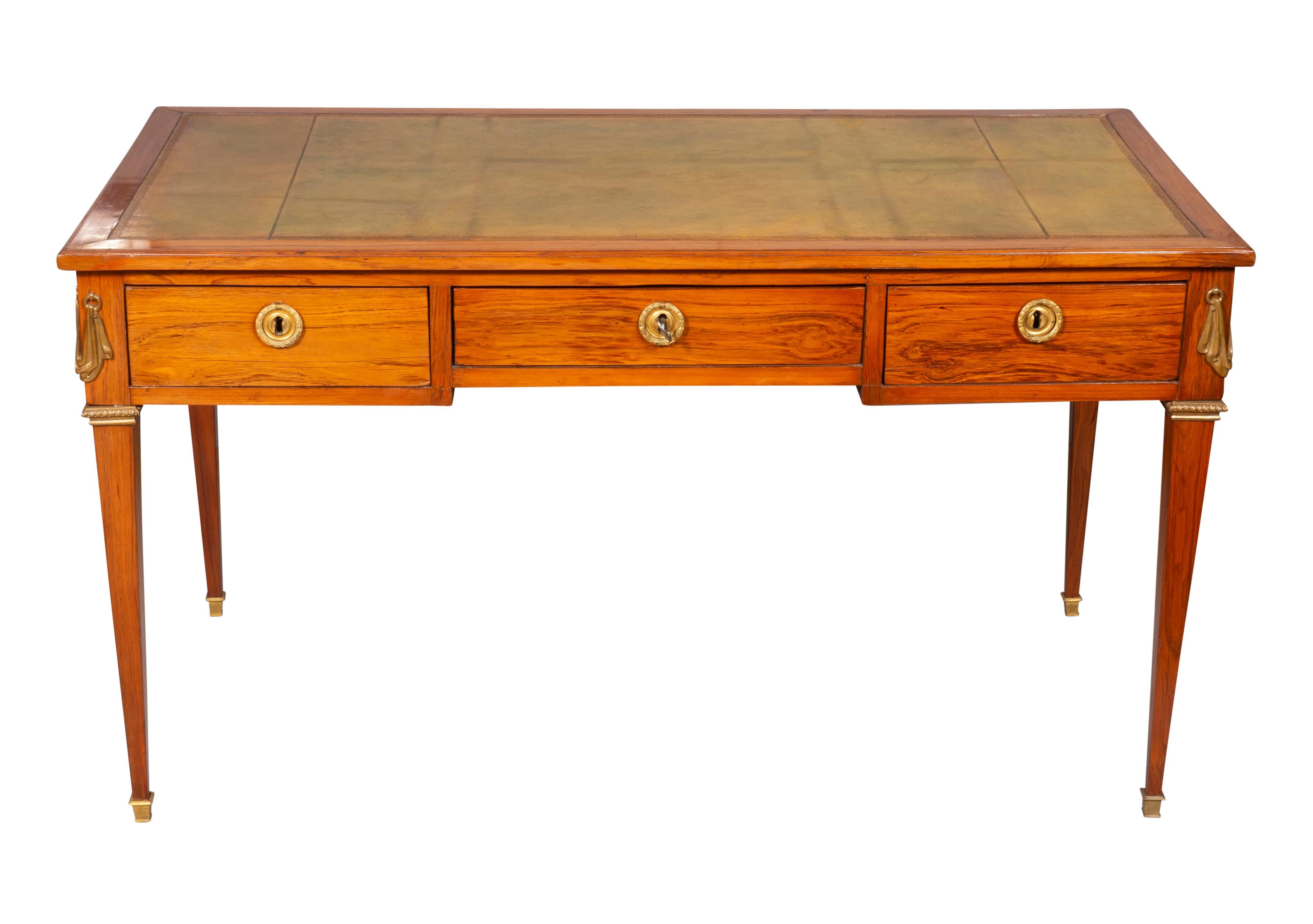 A signed piece with rectangular top with inset green leather, possibly original , over a frieze with one central drawer flanked by drawers each with round original wreath rings with conforming backplates , the reverse of the desk finished with false
