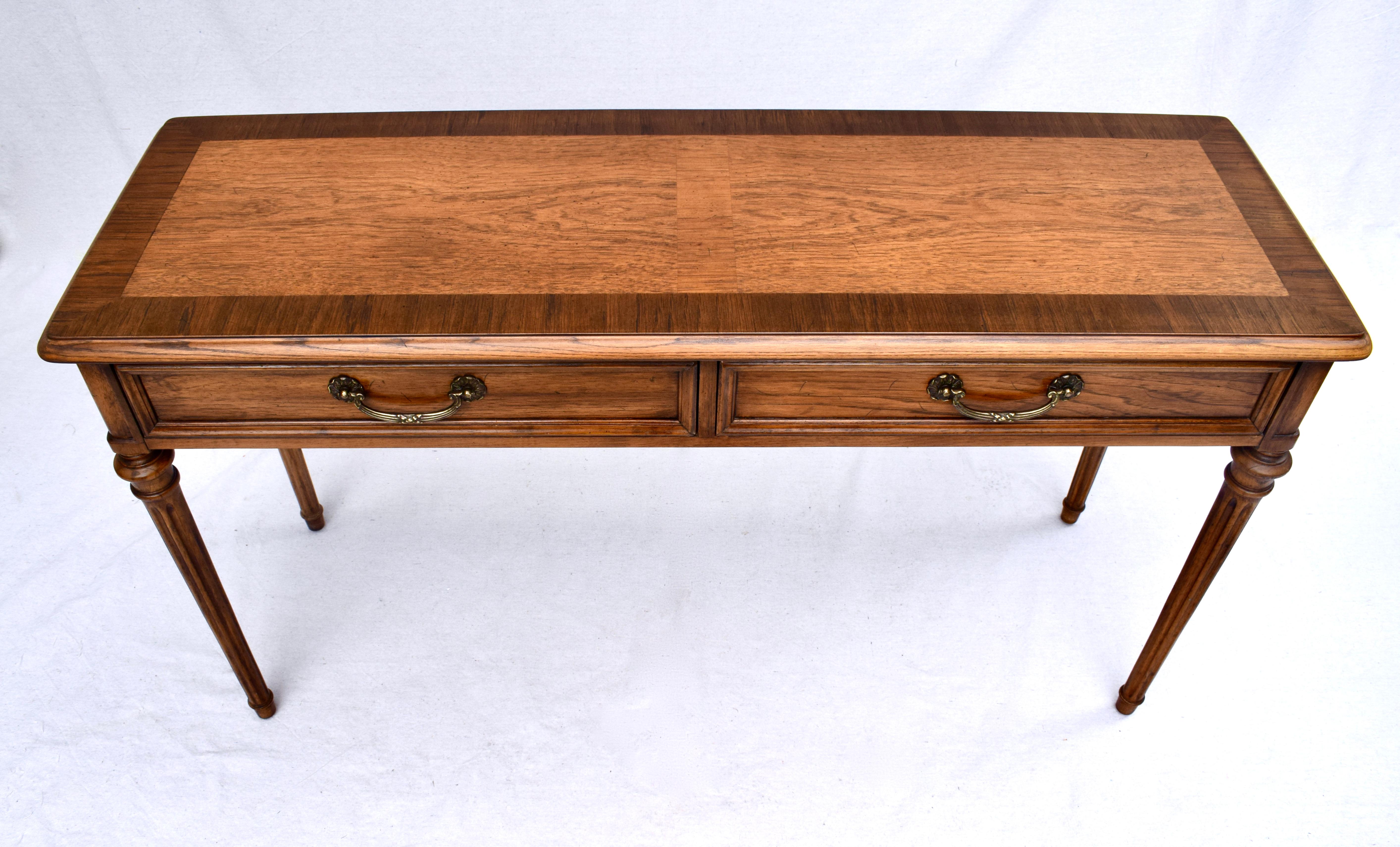 1960's Henredon two drawer Louis XVI style console table of oak with zebra wood banding to the top. Excellent condition with original tag & branding in rarely if ever used condition. Custom refinished top.