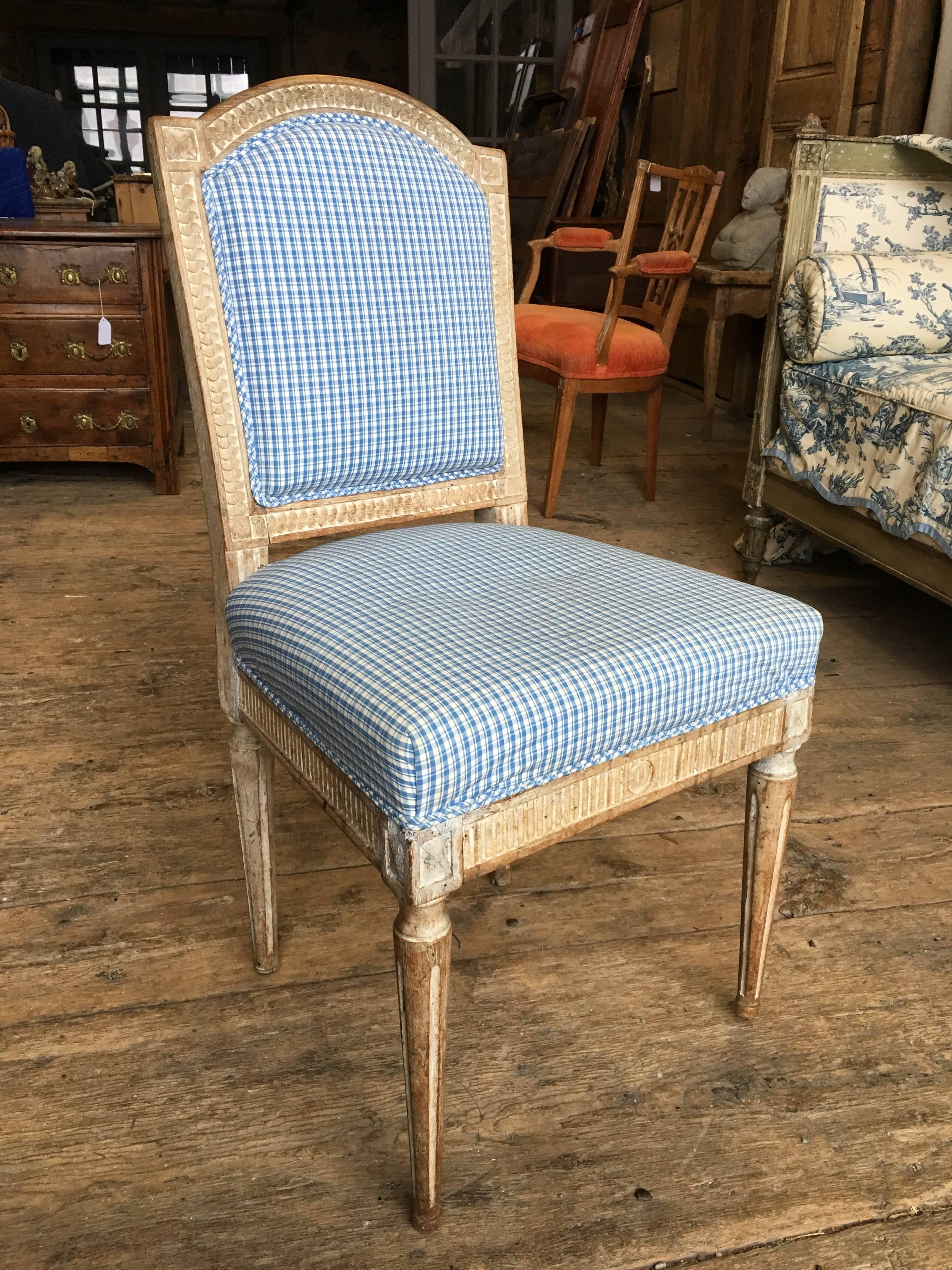 A charming and comfortable Louis XVI period side chair in beech, retaining traces of the original painted finish, nicely carved overall, and upholstered seat and back, circa 1790.