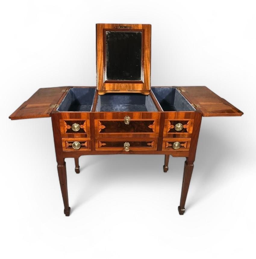 Enhance your bedroom with the sophisticated elegance of this exquisite antique Louis XVI Vanity or Poudreuse from Germany, circa 1780. Crafted from walnut veneer, this exquisite piece features intricate marquetry using on the top, showcasing musical