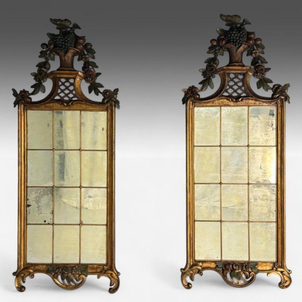 Louis XVI, Wall Mirrors, Giltwood, Antiqued Mirror, Fruitewood Motif 20th C.

This pair of Louis XVI-style wall console/pier mirrors, dating from the 19th or early 20th century, features exquisite carved and painted detailing. Crafted from