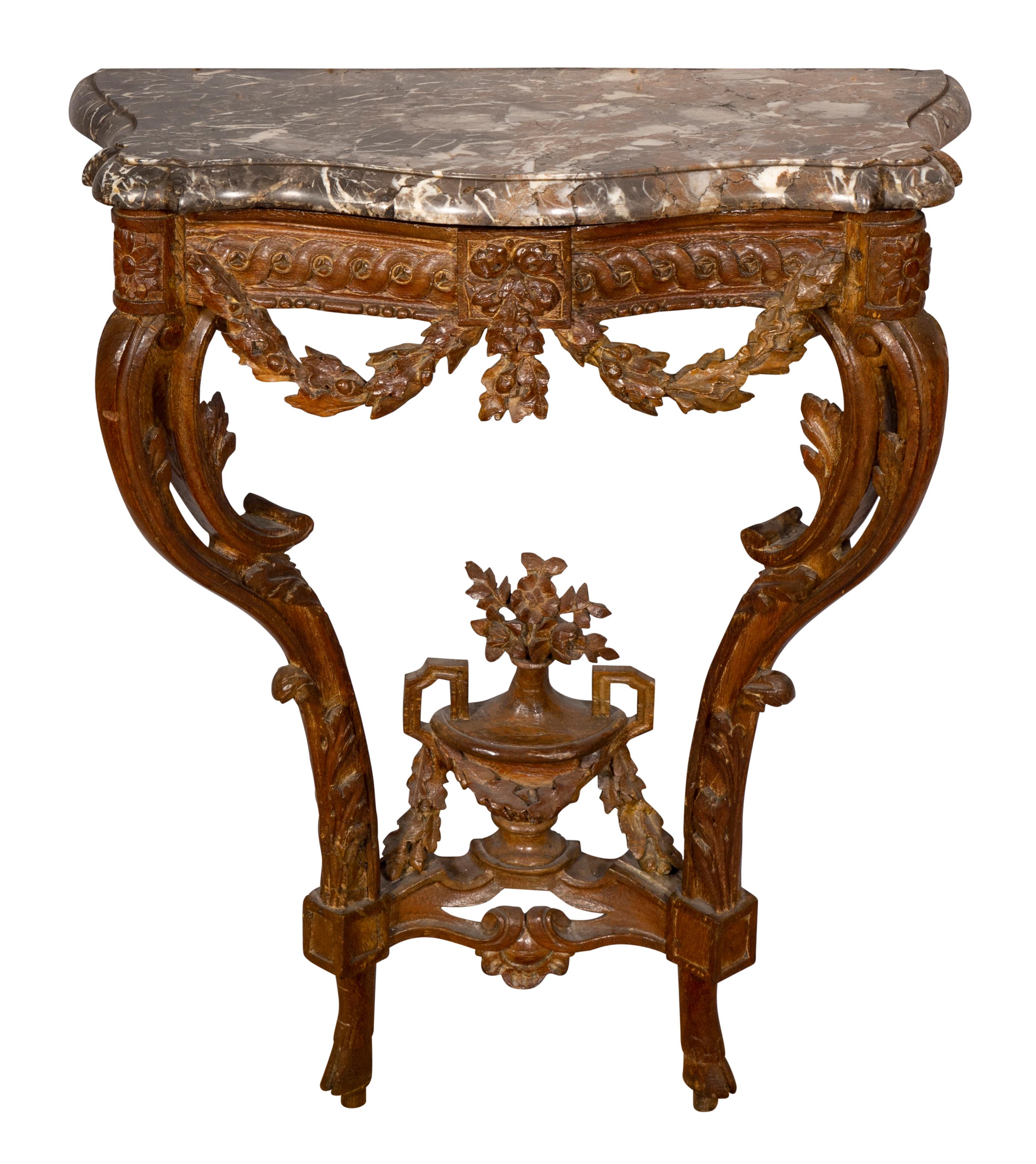 With original shaped marble top on a conforming base with guilloche carved frieze with carved oak leaf swags with a touch of gilding, curved legs with stretcher and central urn with floral finial.