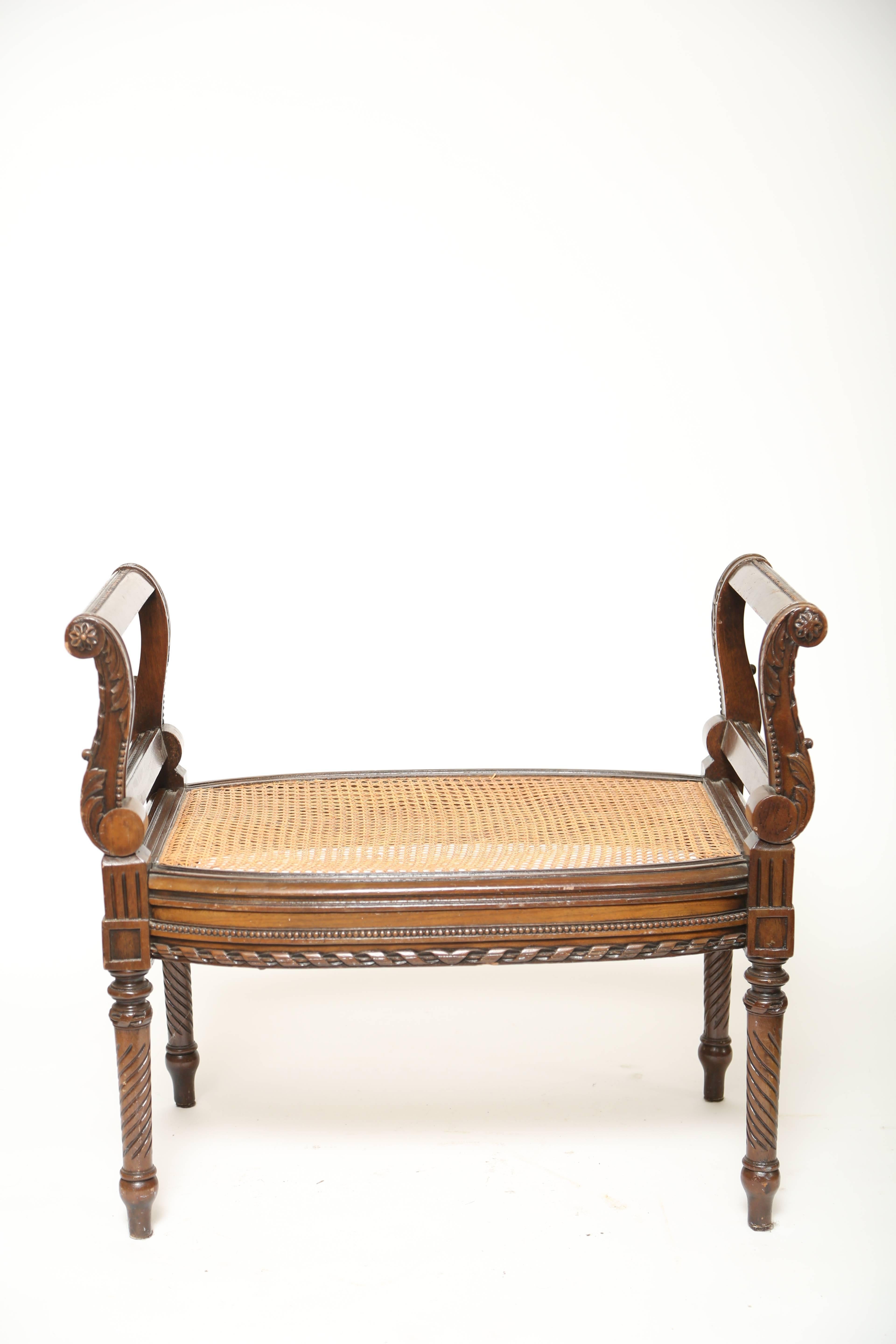 Louis XVI style carved window seat with caned seat. Carved acanthus leaves on side supports and beaded trim with turned ribbon on the apron. The legs are spiral cut.  Looking marvelous as is or with a comfy cushion.
Measures: Seat height 18.75