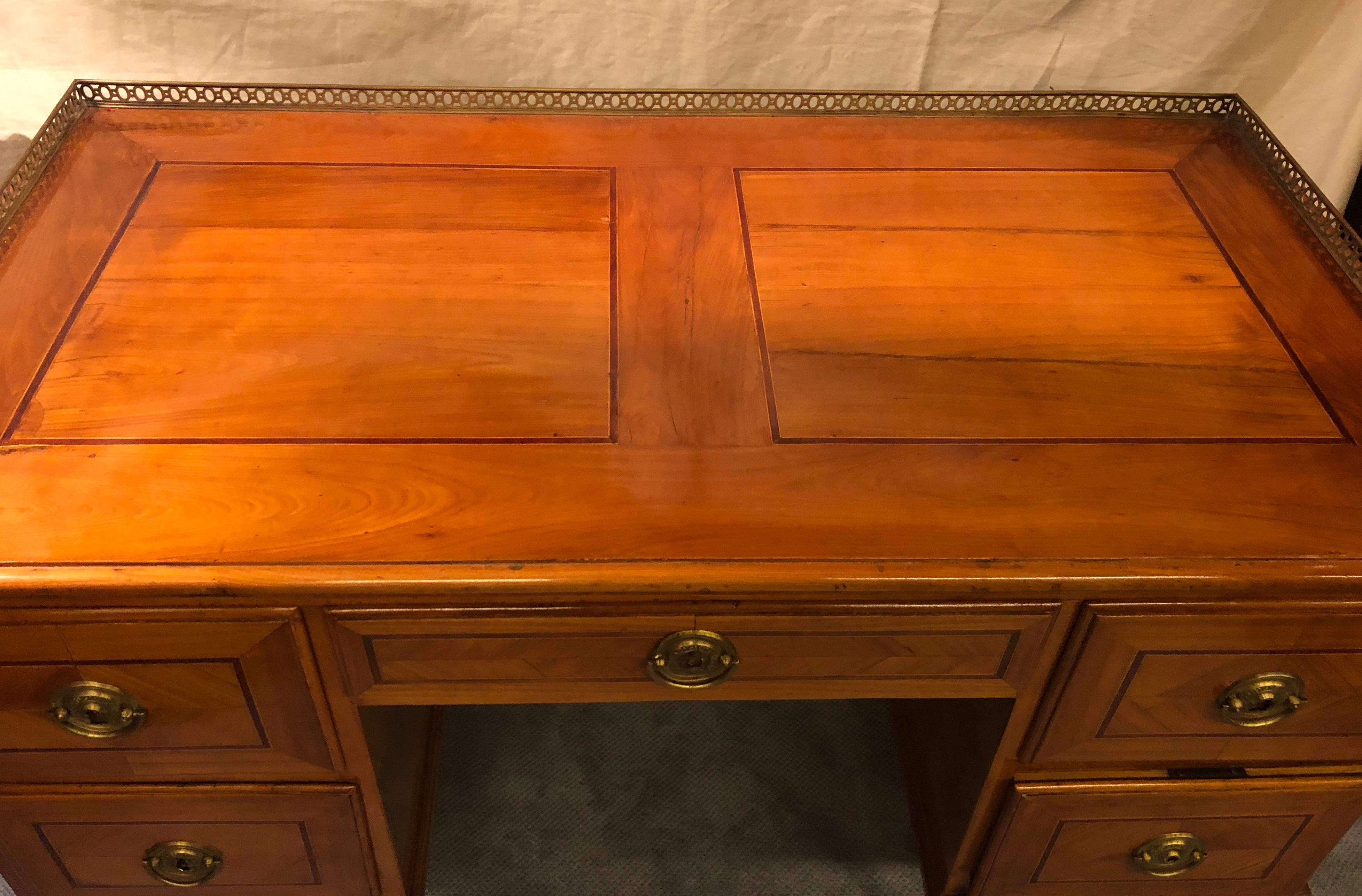 Rare Louis XVI writing desk, South German 1780, exquisite cherry and plum wood veneer on front back, sides and top. The writing top is framed by an open work brass bordering. In very good, refinished condition. The desk will be shipped from Germany.