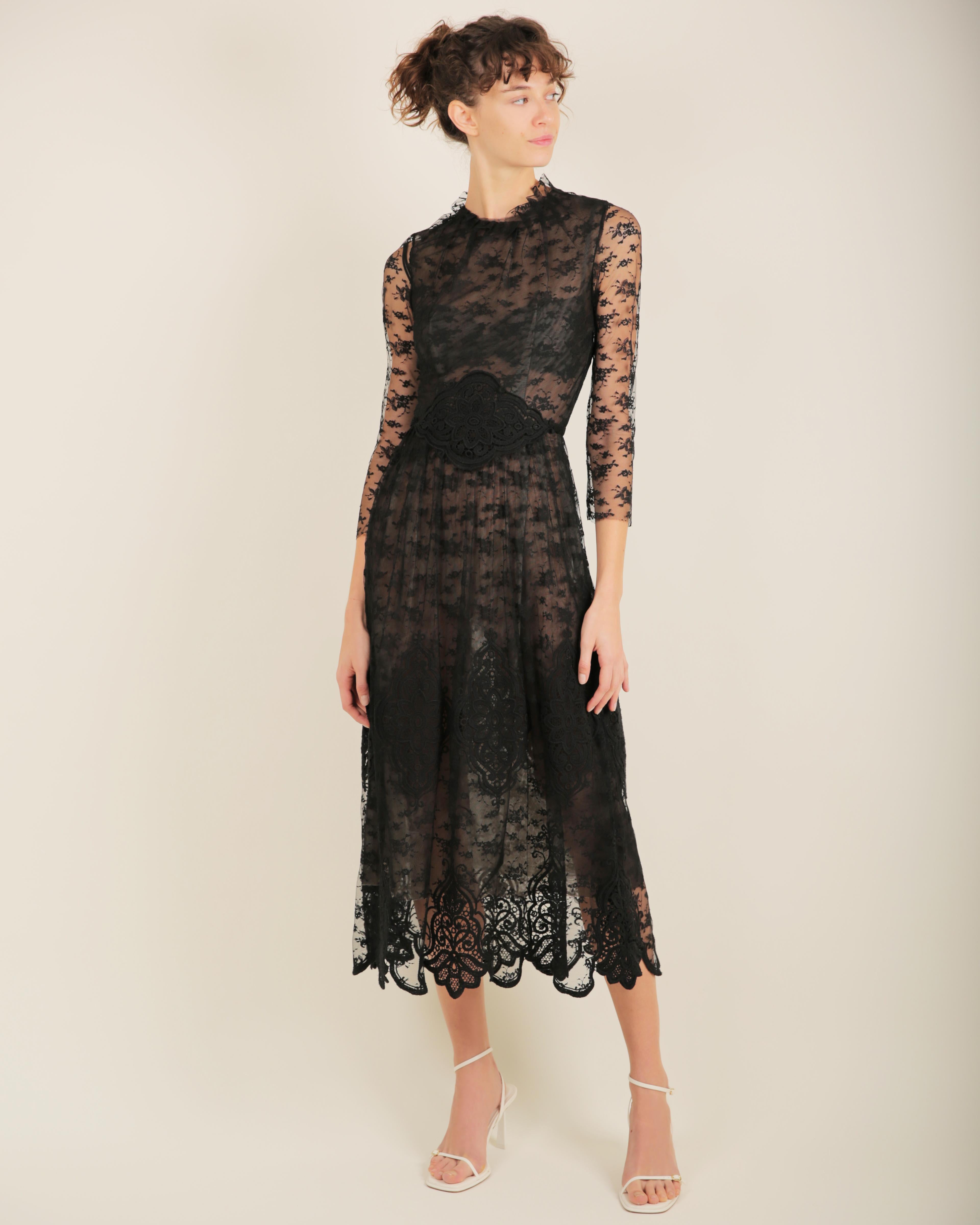 LOVE LALI Vintage

Louisa Beccaria 
Black lace semi sheer dress
Composed of three layers - one layer of nude tulle and one layer of black tulle which is overlayed by a layer of floral black lace inserted with black crochet
Tie waist that ties at the
