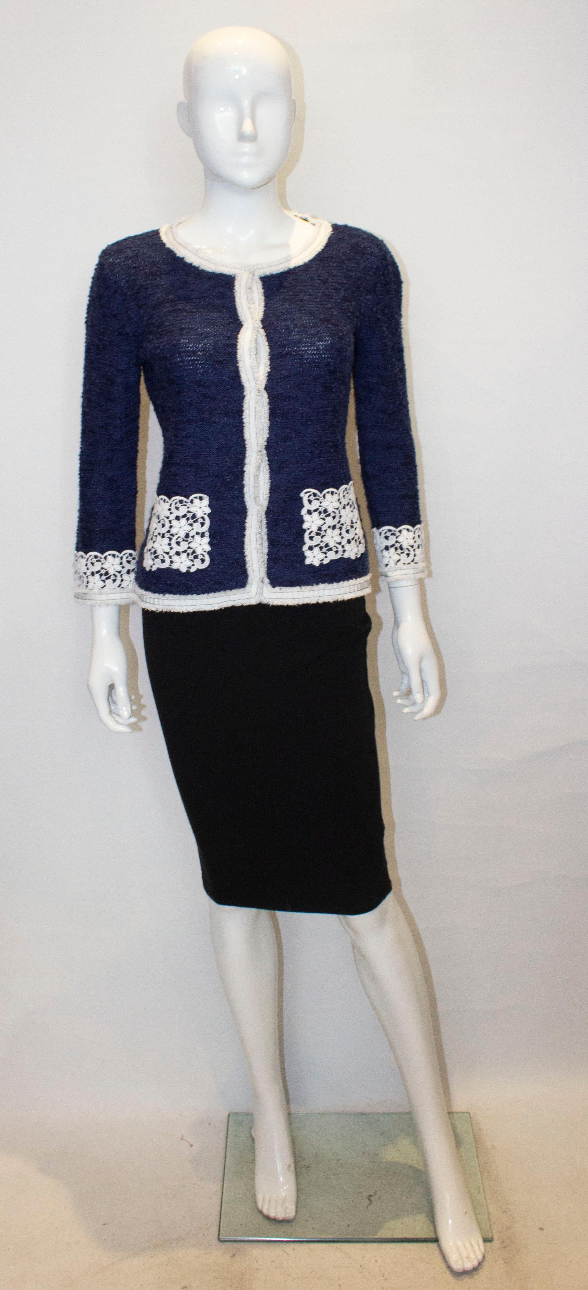 A grat jacket for Spring by Luisa Spagnoli. The jacket is in a blue knit fabric with a round collar , popper fastening, two lace pocket and lace detail on the cuffs.