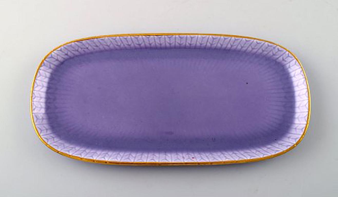 Louise Adelborg (b.1885, 1971) for Rörstrand / Rorstrand, Sweden. Set of one long and four small Swedish Grace dishes in purple with gold decoration. 1930s-1940s.
Louise Adelborg was a Swedish designer of porcelain and textiles. She worked for