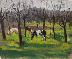 Cows Munching On Green Grass In French Woodland Landscape