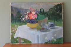 Large Still life of flower and jug on a table top in garden setting