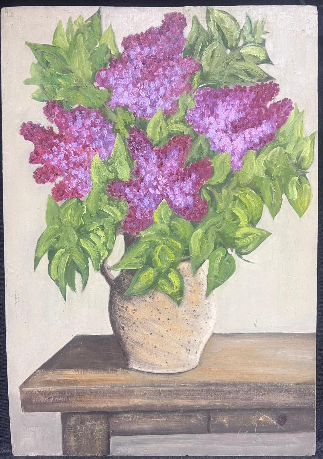 Purple Lilacs
by Louise Alix (French, 1888-1980) *see notes below
provenance stamp to the back 
oil painting on board , unframed
measures: 22 high by 15 inches wide
condition: overall very good and sound, a few scuffs and marks to the surface and