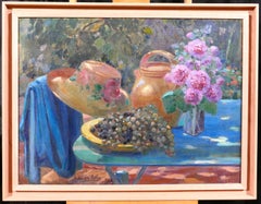 Still life in the garden: flowers, grapes and hat