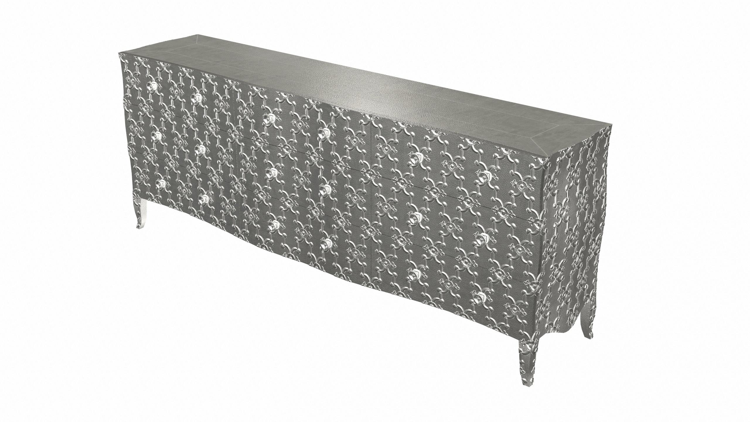 Renowned designer Paul Mathieu created this large dresser with 9 drawers with his interpretation of Fleur de Lis motif carved all over the piece just like the other two designs namely the Louise Semainier and Demi Louise Semainier which are part of