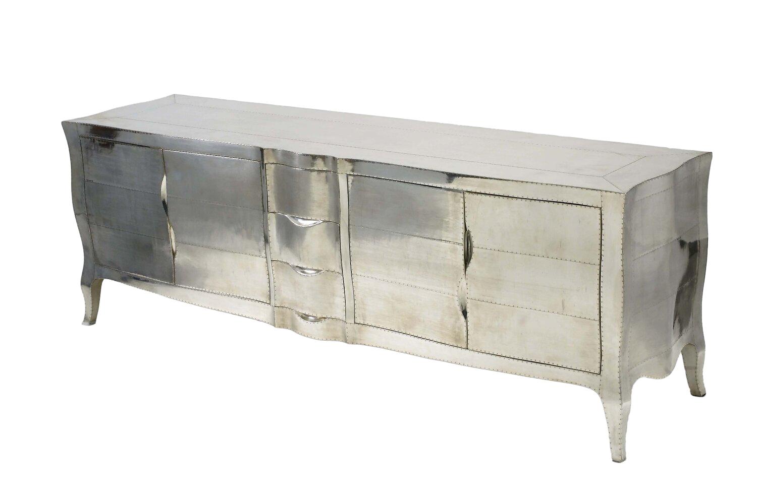 Louis XV credenza dresser sideboard in white bronze was designed by the renowned designer Paul Mathieu. He created this credenza dresser sideboard which is a more feminine version of Louis XV (1730-1760) furniture. This credenza dresser features the