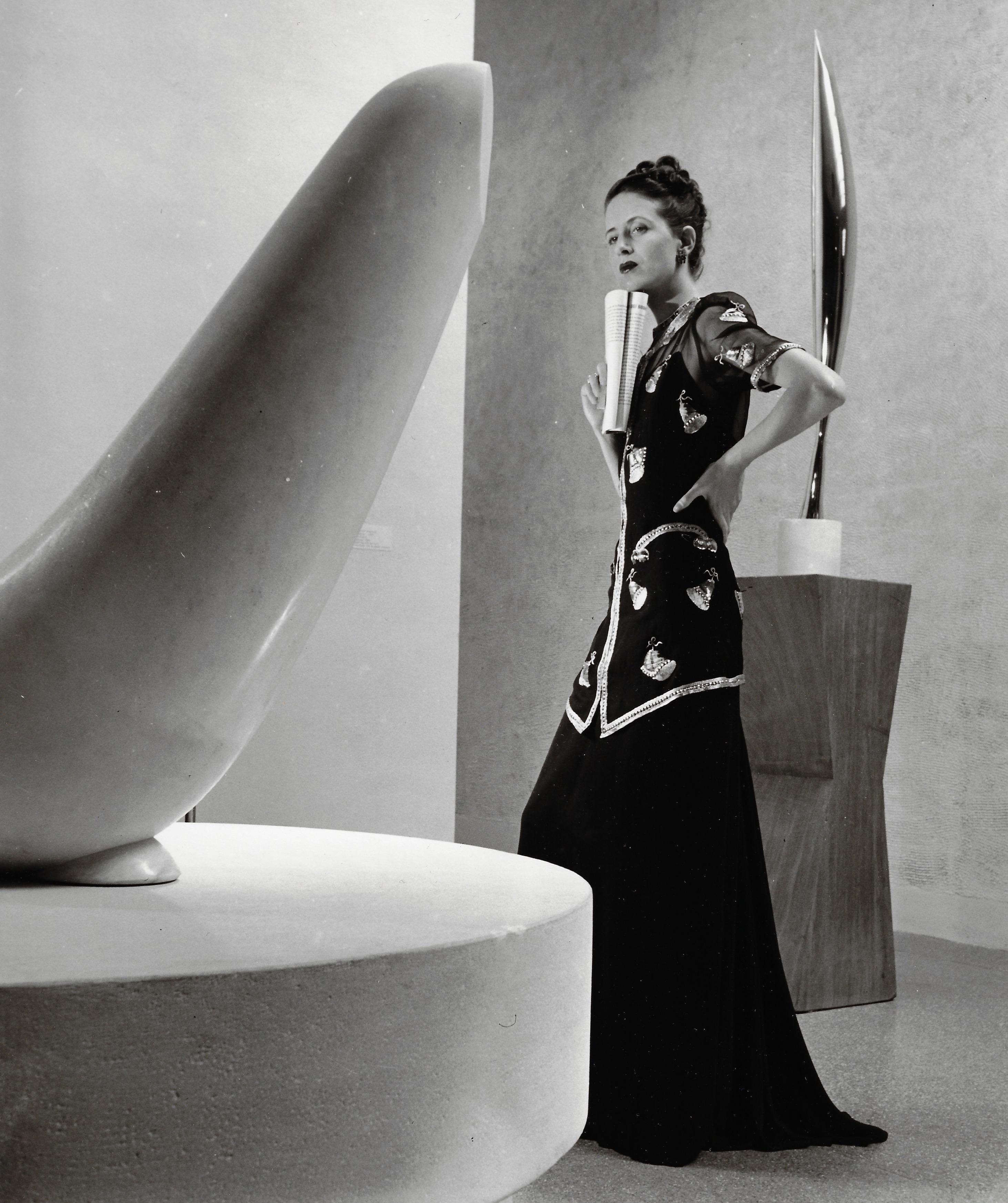 Louise Dahl-Wolfe Black and White Photograph - Model Shelly Napier in Schiaparelli with Brancusi Sculptures, MOMA, New York