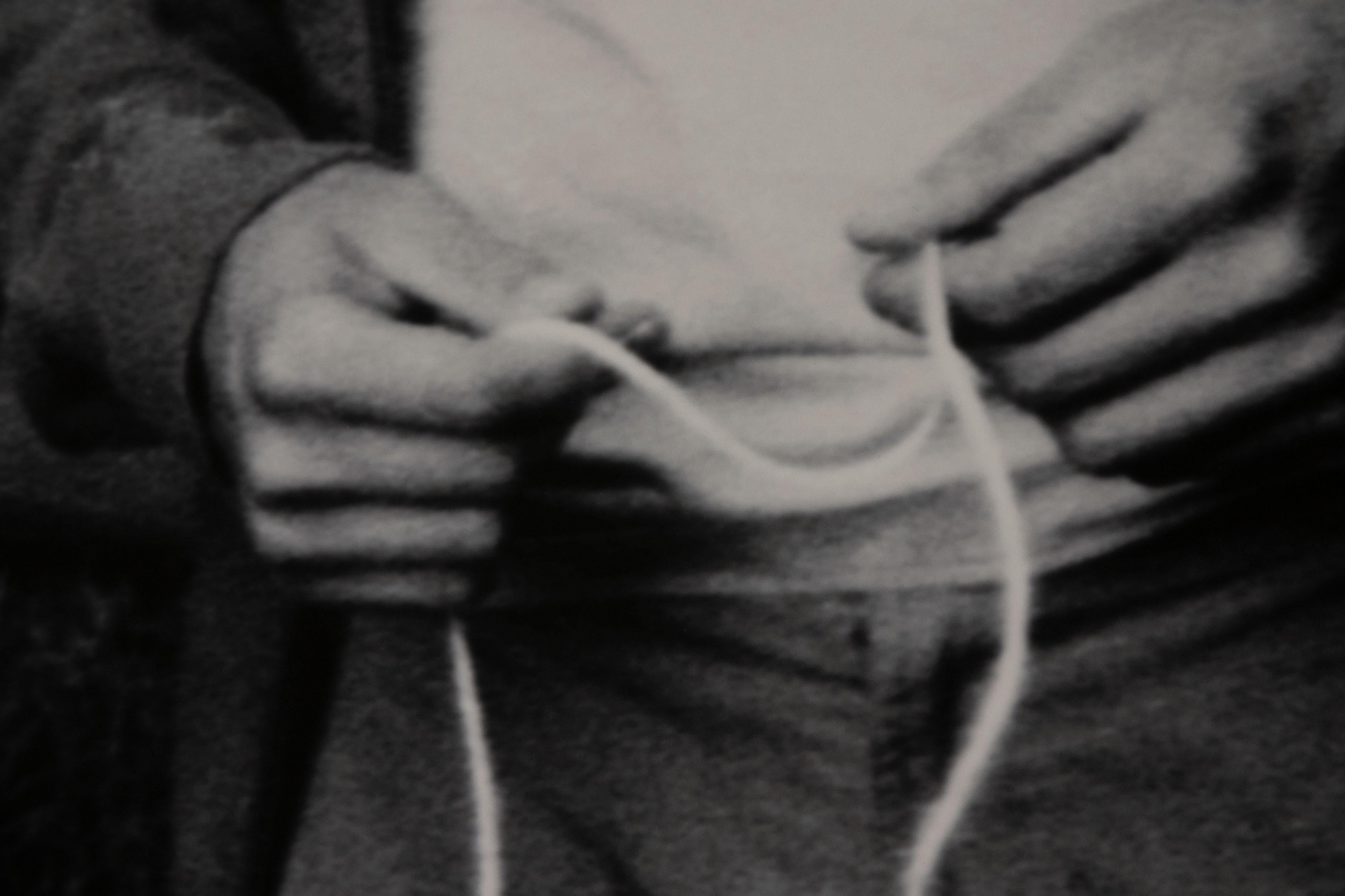 Photo en noir et blanc d'un homme tenant une ficelle, intitulée 'You're wondering why...' (Vous vous demandez pourquoi ?). - Noir Black and White Photograph par Louise Degraeve