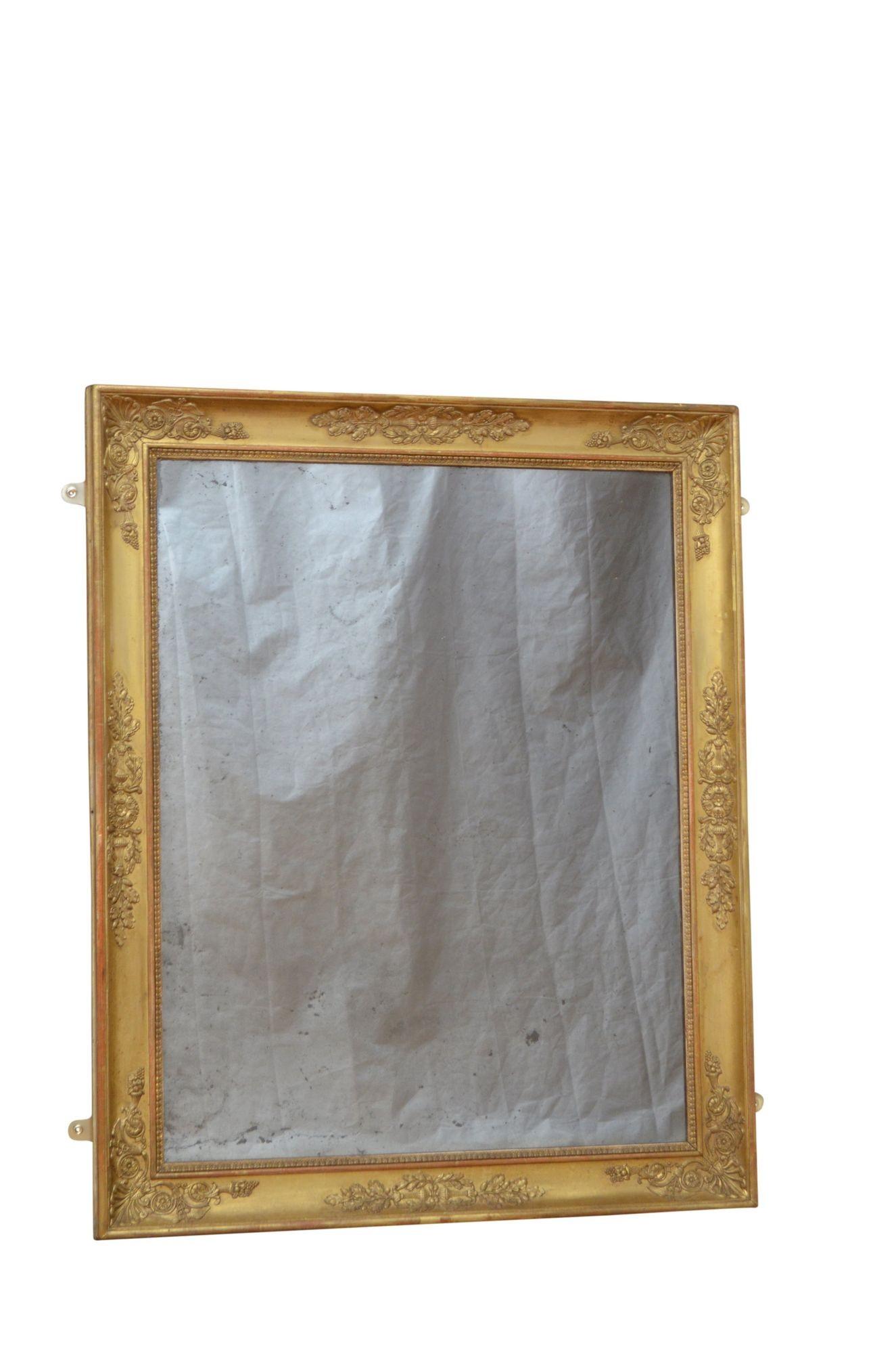 P0150 Fine XIXth century gilded wall mirror which can be positioned horizontally or vertically, having foxed glass in carved gilt frame decorated with intricate floral designs including oak leaf with acorns, horn of plenty and caduceus which is the