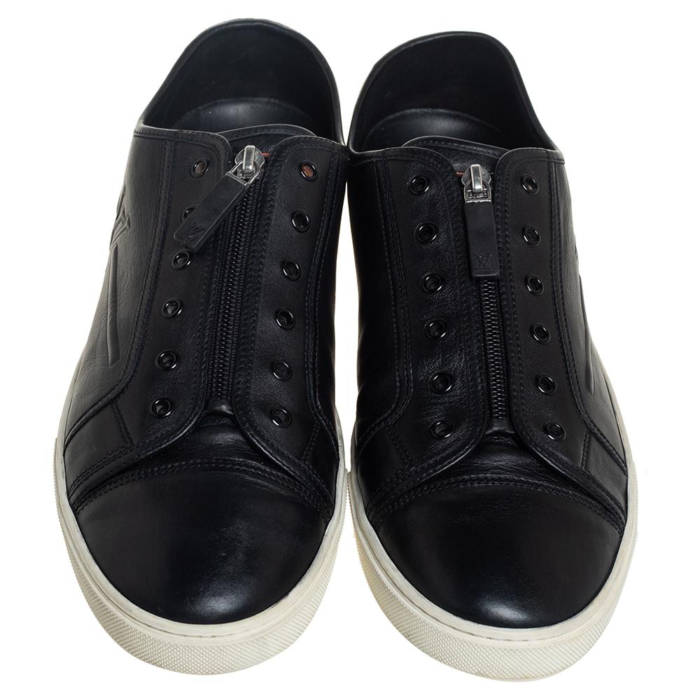 Experience footwear ease with this pair of black low-top sneakers by Louis Vuitton. They've been crafted from leather and detailed with lace eyelets and zip closure on the uppers. The leather insoles add to the comfort of the pair.

