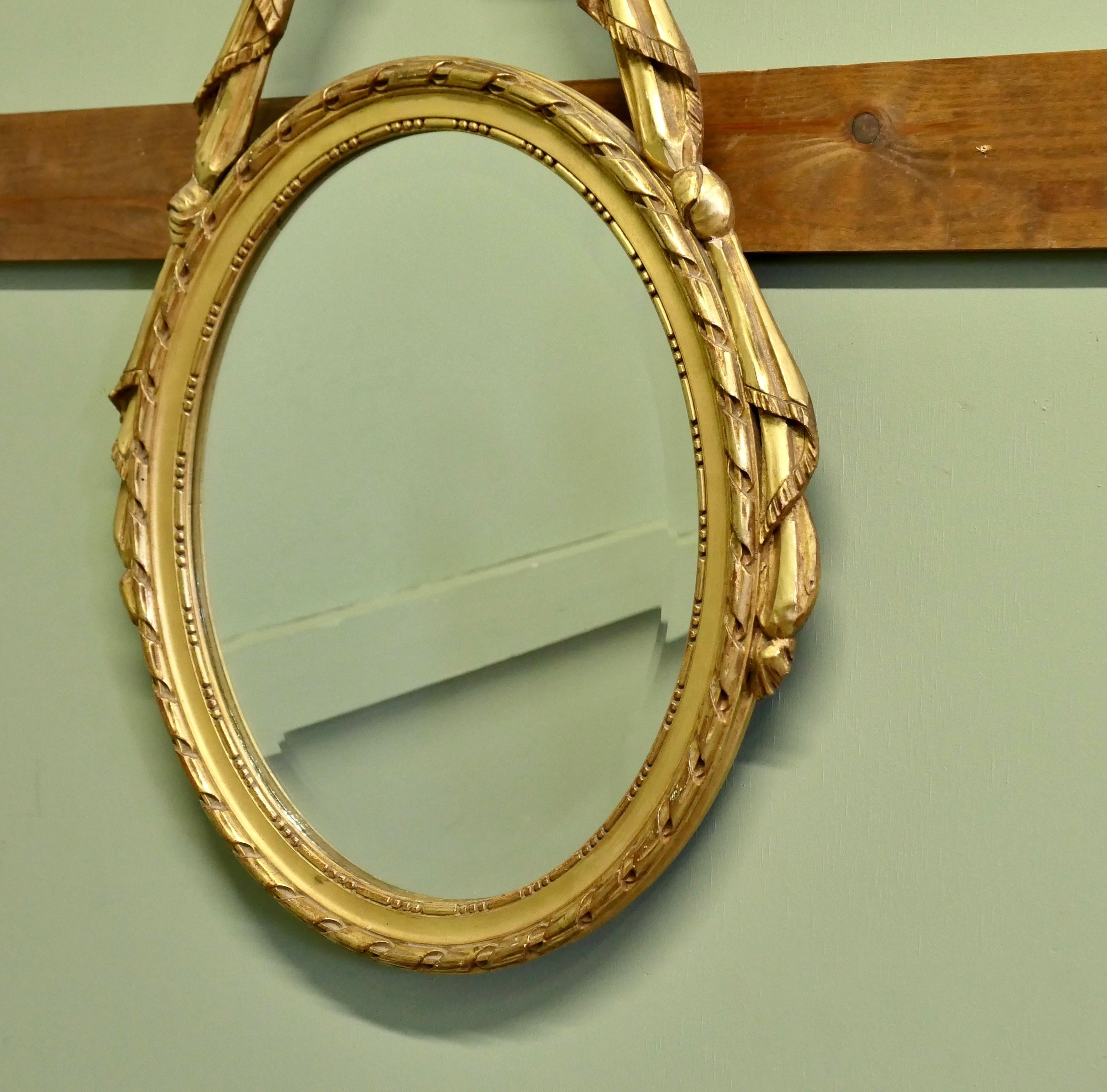French Provincial LouisXVI Style Gilt Ribbon and Bow Mirror Oval Mirror  A superb piece For Sale