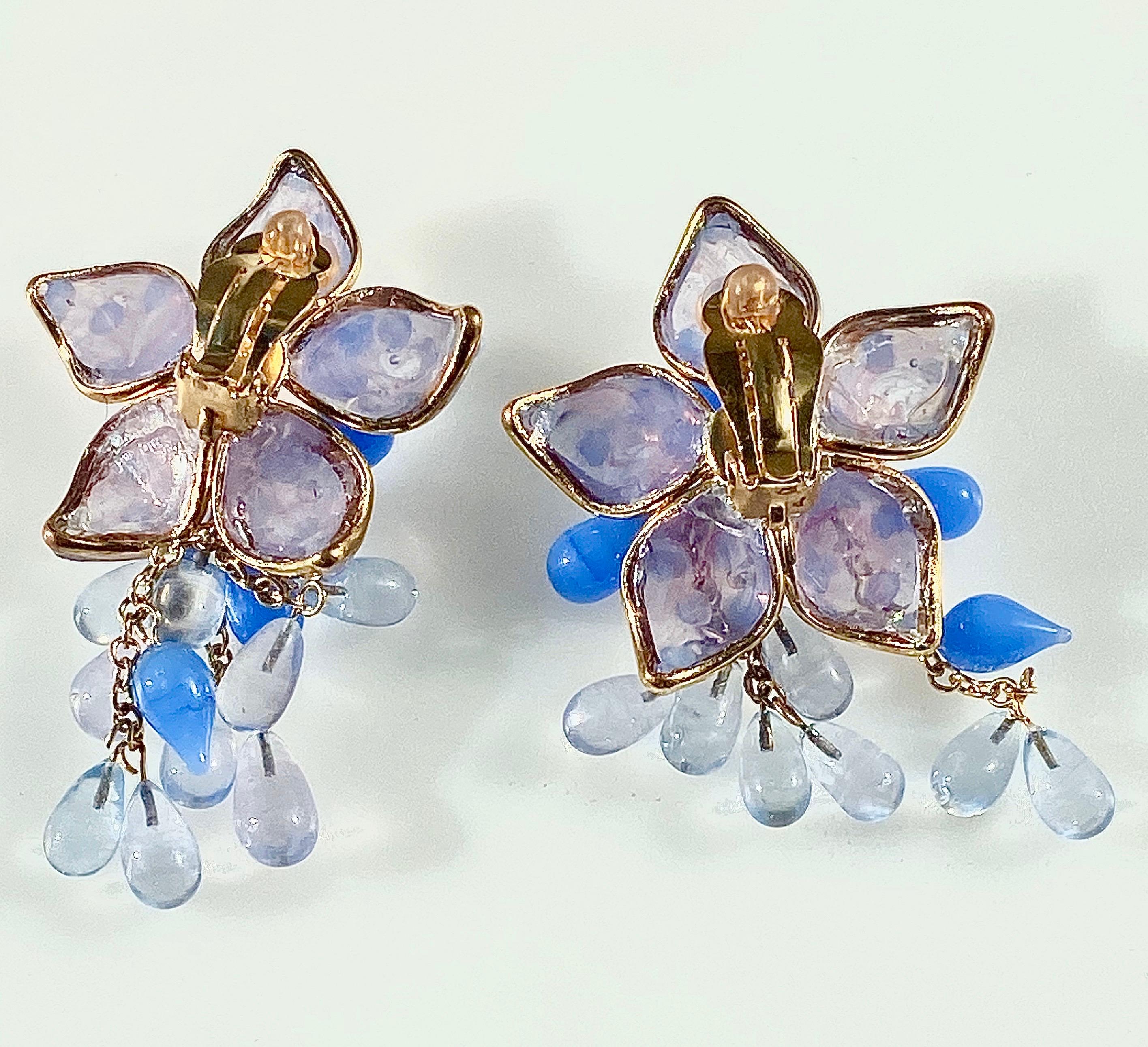 These 1980’s couture earrings are a swinging floral bouquet that reflects the electric charm of Loulou de la Falaise and the extraordinary craftsmanship of Maison Gripoux. These were hand made in Paris using poured glass and gilt material. Many