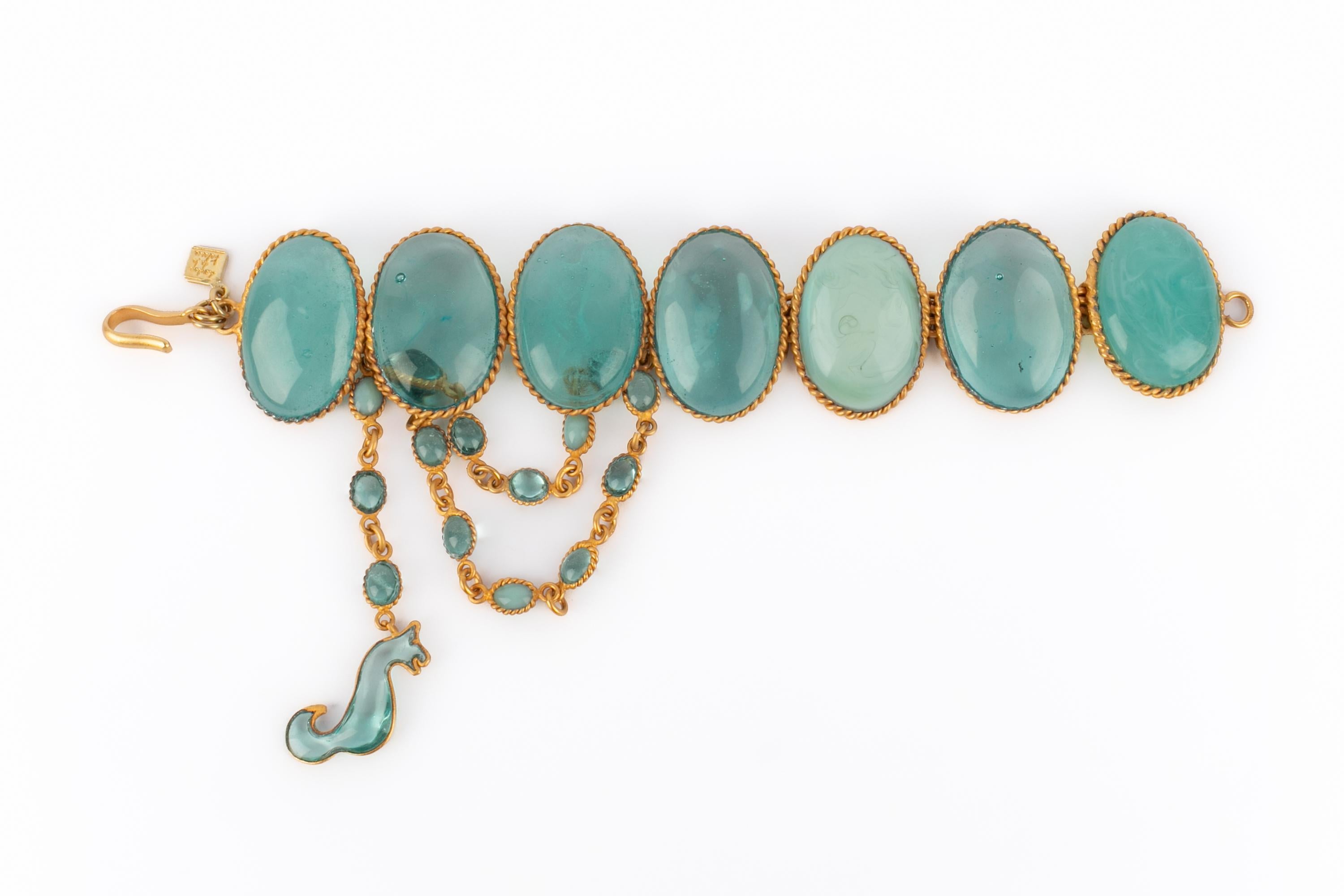 LOULOU DE LA FALAISE - Golden metal bracelet with blue glass paste.

Condition:
Very good condition

Dimensions:
Length: 17 cm

SKU:BRA16