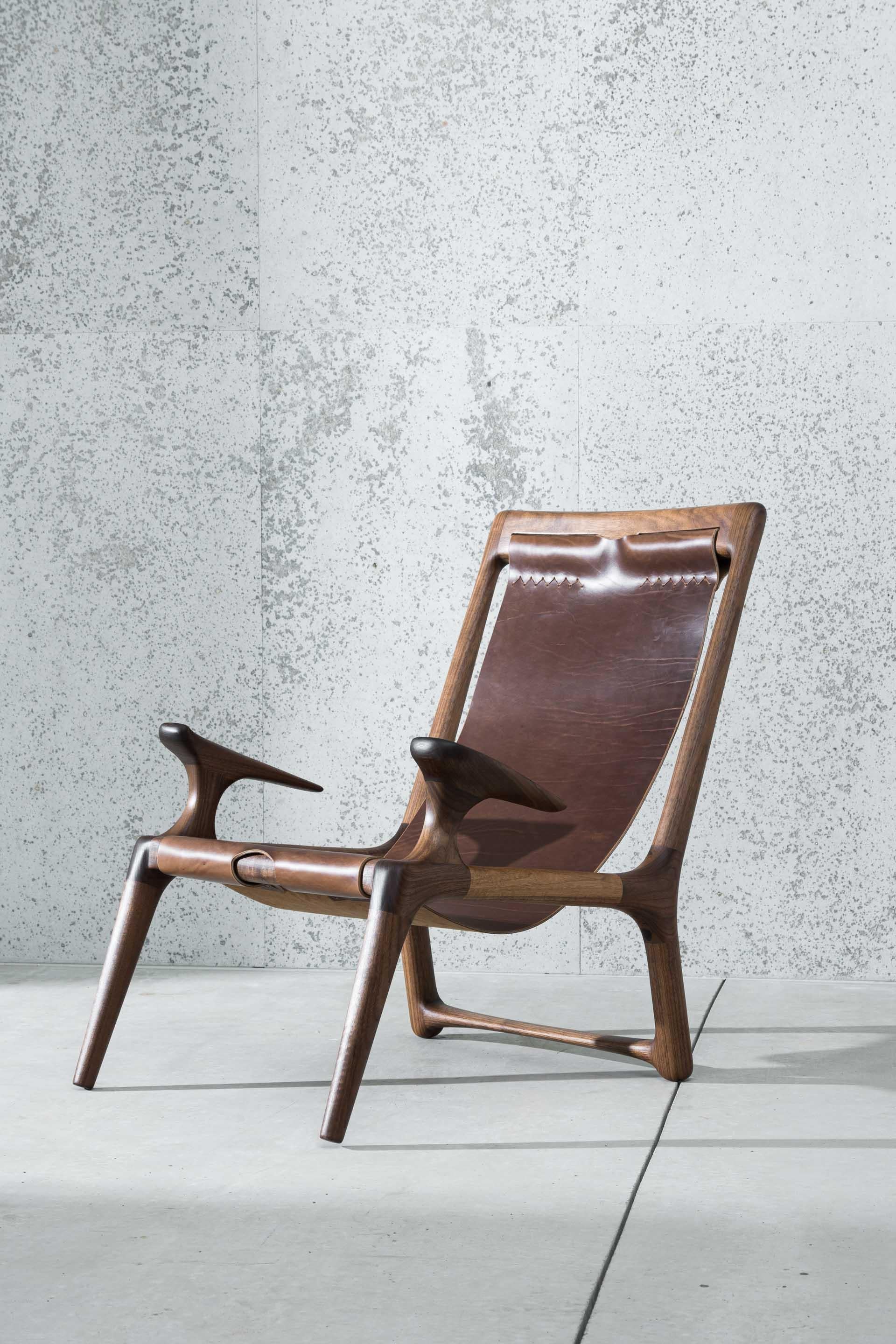 This award winning piece is the inaugural chair design by Fernweh Woodworking. The frame is hand-shaped from high quality American Walnut, providing rich warm brown tones with sleek joinery inspired by Danish, Scandinavian, and mid-century modern