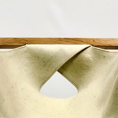 Lounge armchair in Lenga wood and wool felt seat