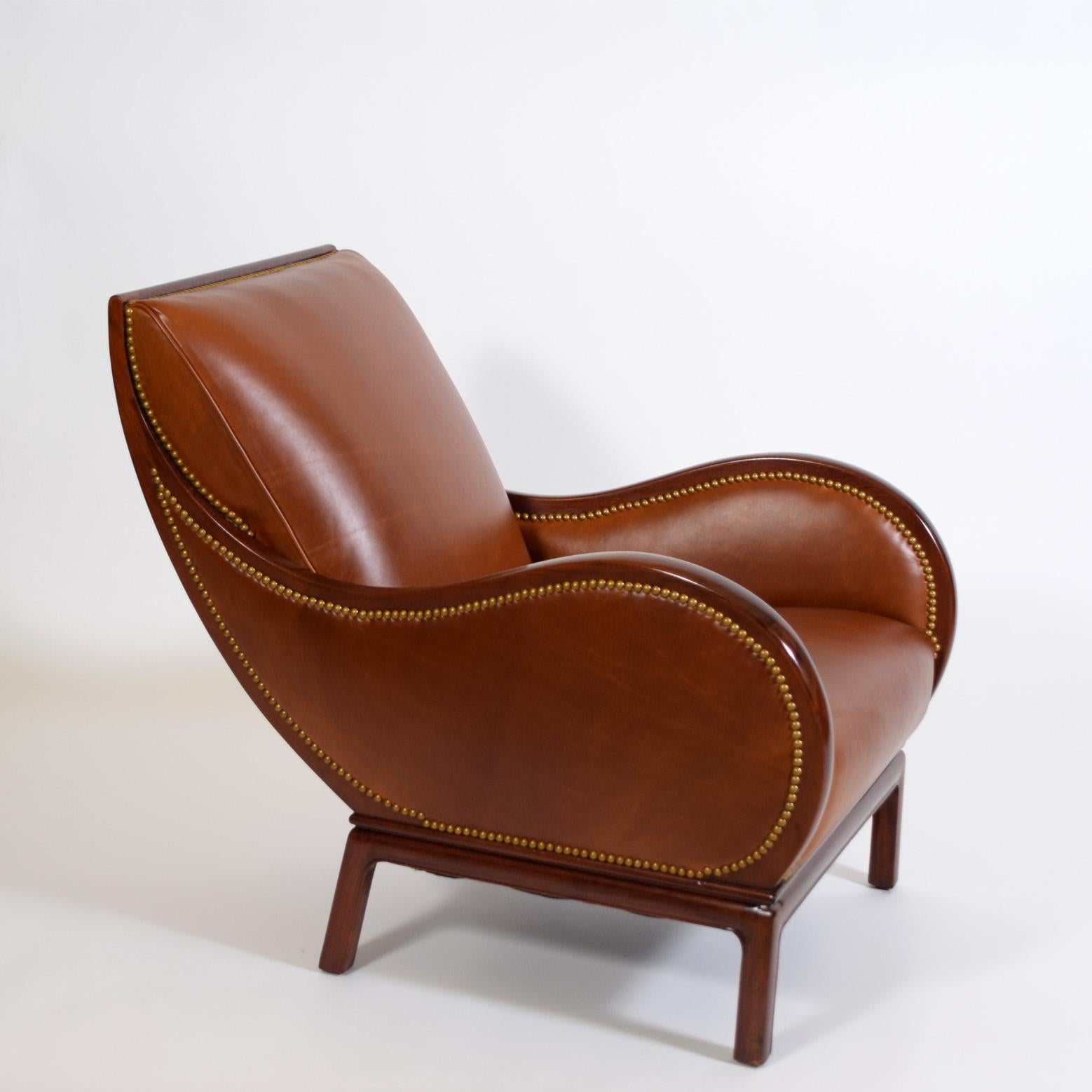 Very unique and early lounge chair by Danish Modern Designer, Frits 
Henningsen.   Unusual stand-out form in the swirling curve of the arms and 
back, reupholstered in soft brown leather fitted with brass studs
Frits Henningsen (1889–1965) was a