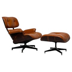 Fauteuil de salon et repose-pieds Charles Eames pour Herman Miller en cuir orange