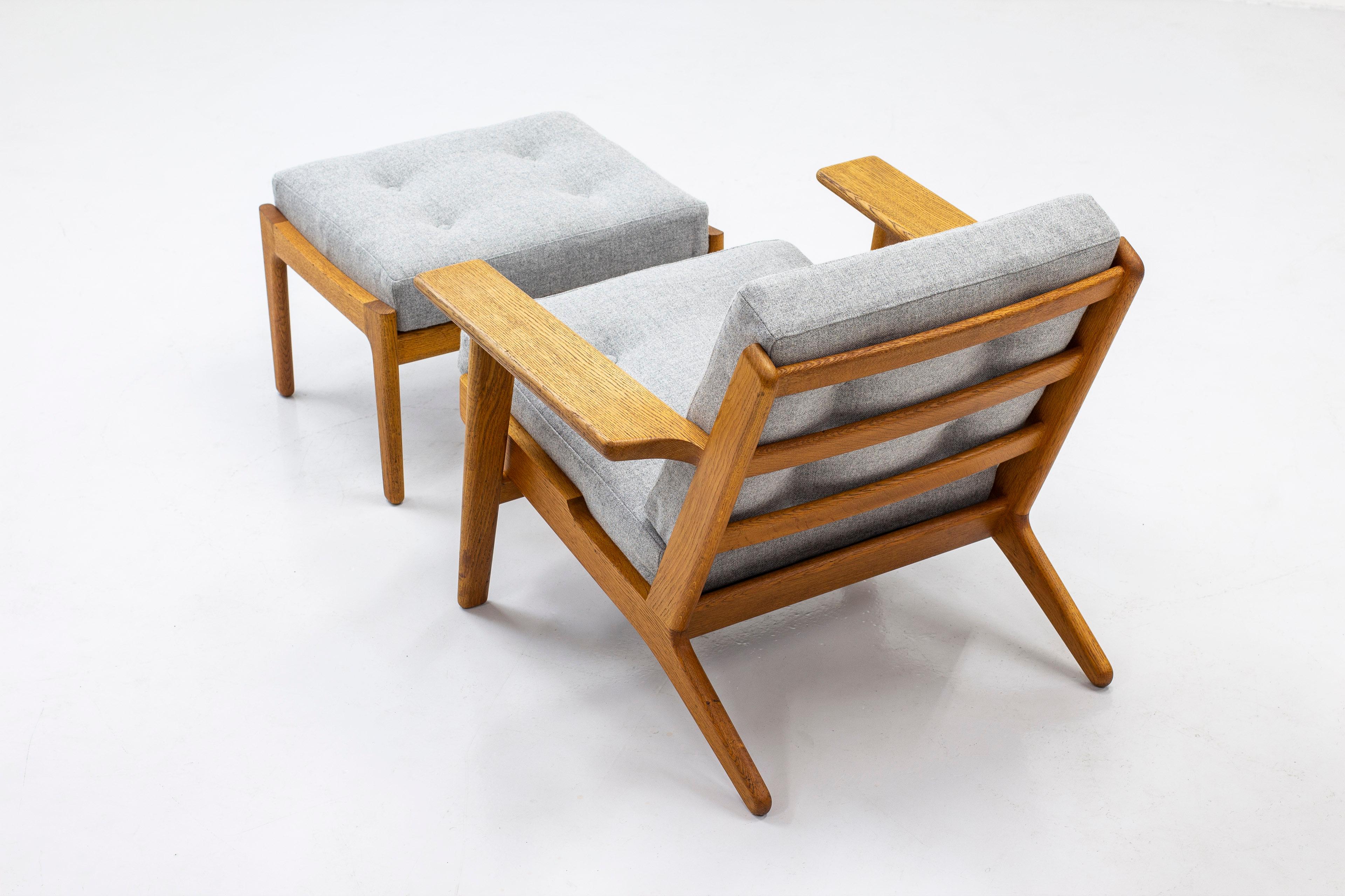 Lounge chair model GE-290 and ottoman designed by Hans J. Wegner. produced by GETAMA in Denmark in the 1960s. Made from solid oak. Cushions with new grey wool fabric from Kvadrat. Excellent vintage condition with very few signs of age and use. Both
