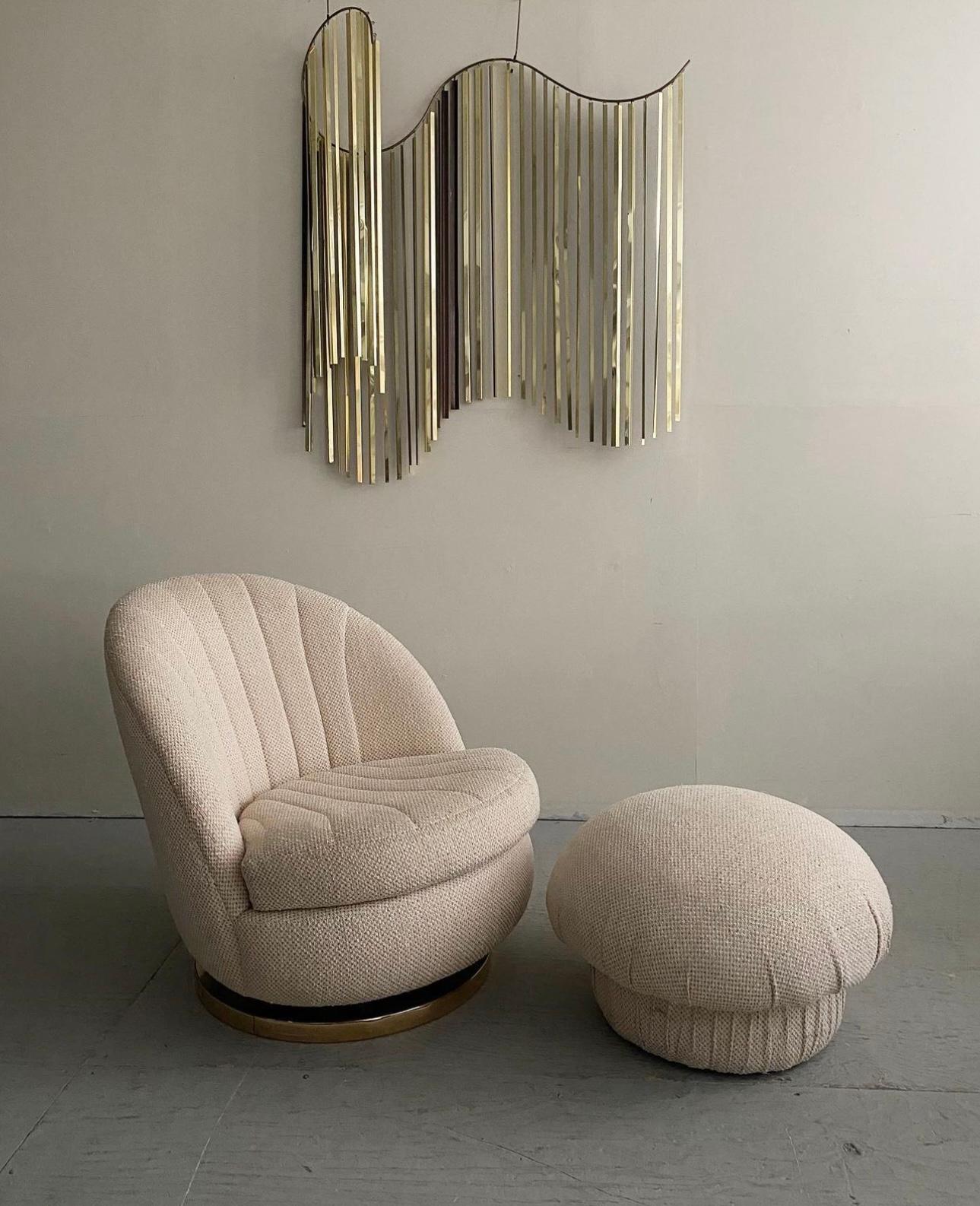 Mid-Century Modern Shellback Lounge Chair And Ottoman Designed By Milo Baughman for Thayer Coggin, Circa 1960s. This unique lounge chair and ottoman feature original off-white textured upholstery. Sits on a solid brass base that allows for a