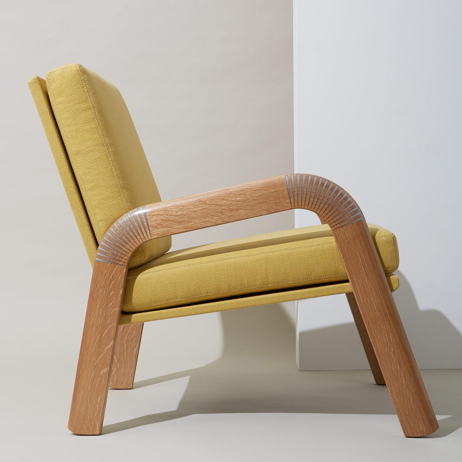 This item is made to order and customizable.

Kerf lounge chair by Noble Goods. Arms are made from quarter-sawn white oak that has been kerf-cut, bent, and inlaid with translucent white epoxy resin. Upholstered in Romo “Osumi” cotton in color
