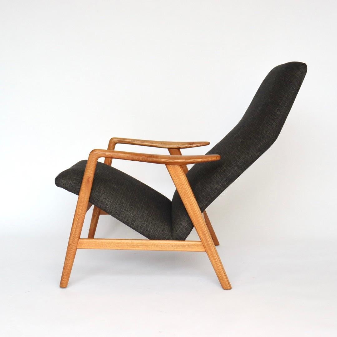 This Danish high back lounge chair was designed by Alf Svensson for Fritz Hansen circa 1950s. The red oak base has been restored and the upholstery was re-done recently by the previous owner. Because of it's beautiful base, short arms, and