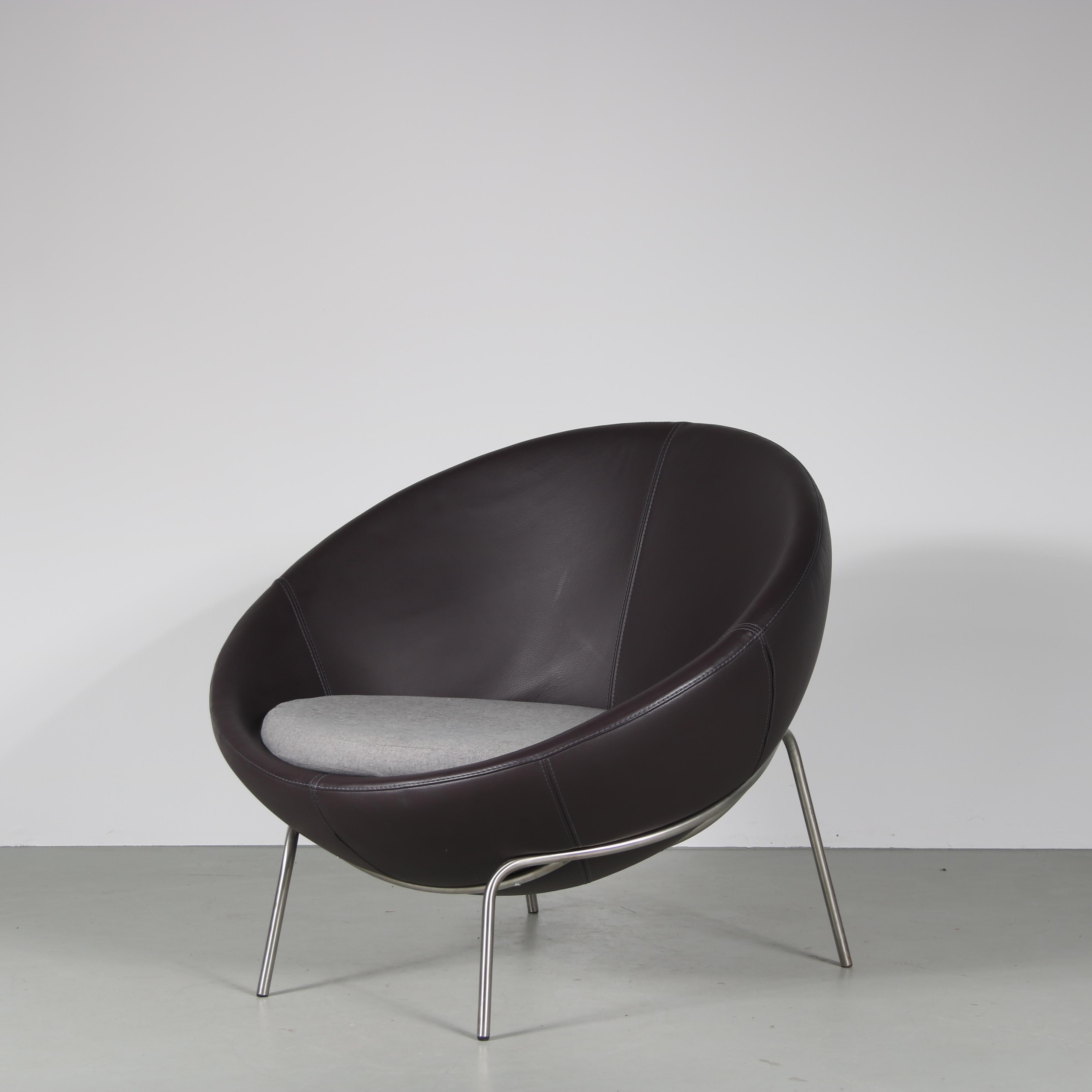 A lovely lounge chair, manufactured by Bert Plantagie in the Netherlands around 2000.

This eye-catching, modern piece has a large round shell upholstered in high quality dark aubergine coloured leather. It holds a grey wool cushion which nicely