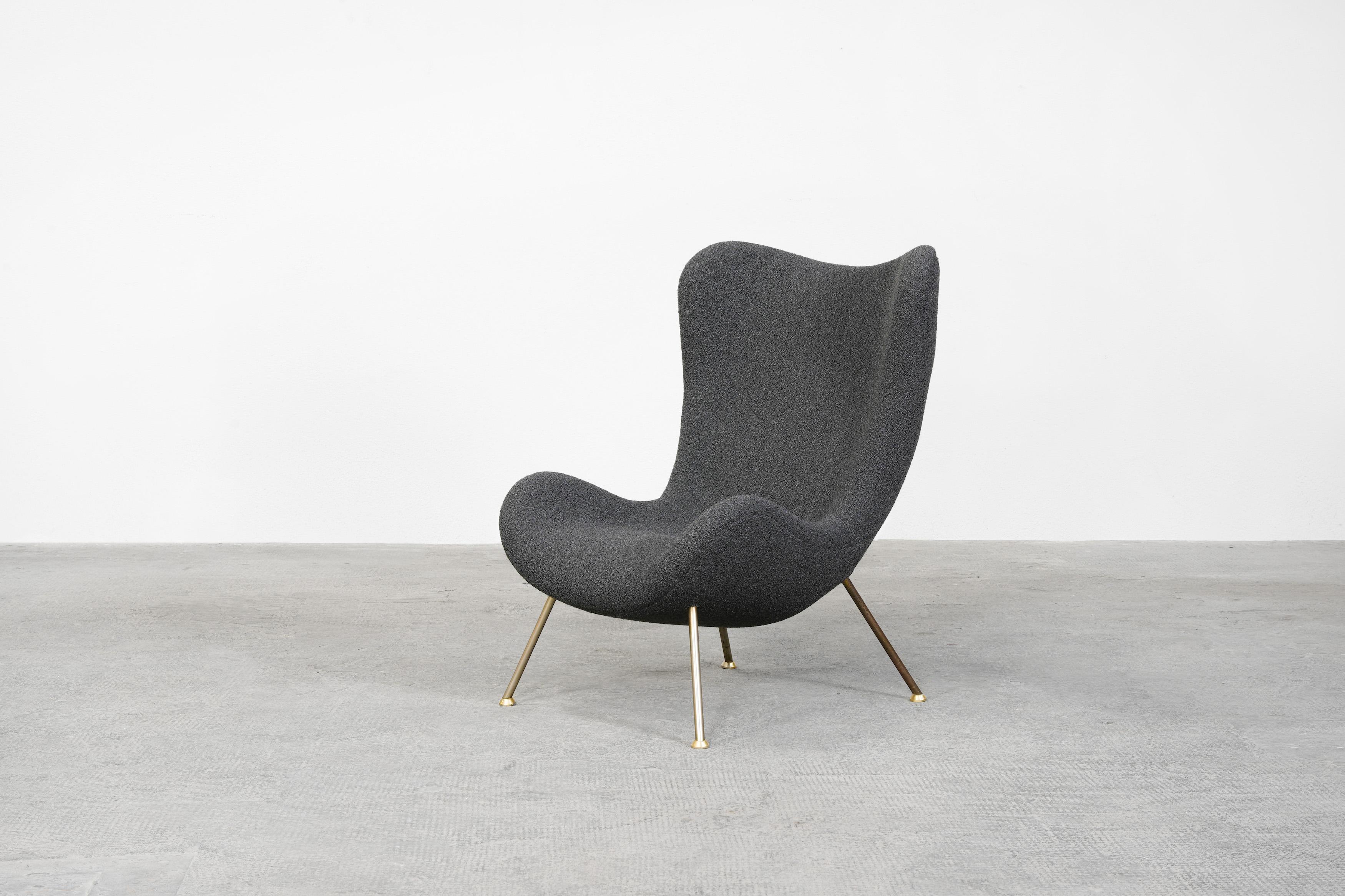 Lounge chair designed by Fritz Neth and produced by Correcta in Germany, 1955.
Organically shaped seat shell on gold-plated metal legs and with new upholstery, in high-quality grey boucle. 
The chair is extremely comfortable and comes in excellent