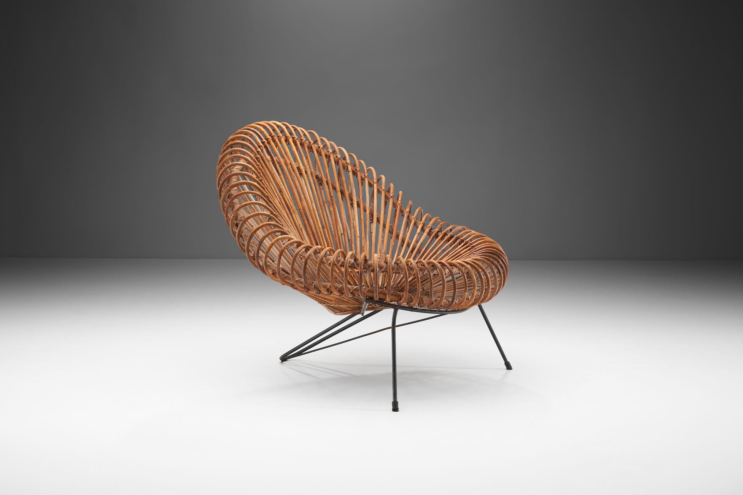 This beautiful woven rattan chair combines Janine Abraham’s imagination with Dirk Jan Rol’s architectural construction skills. 

From the circular woven center to the shell of the seat, the craft of the designer and manufacturer is outstanding.