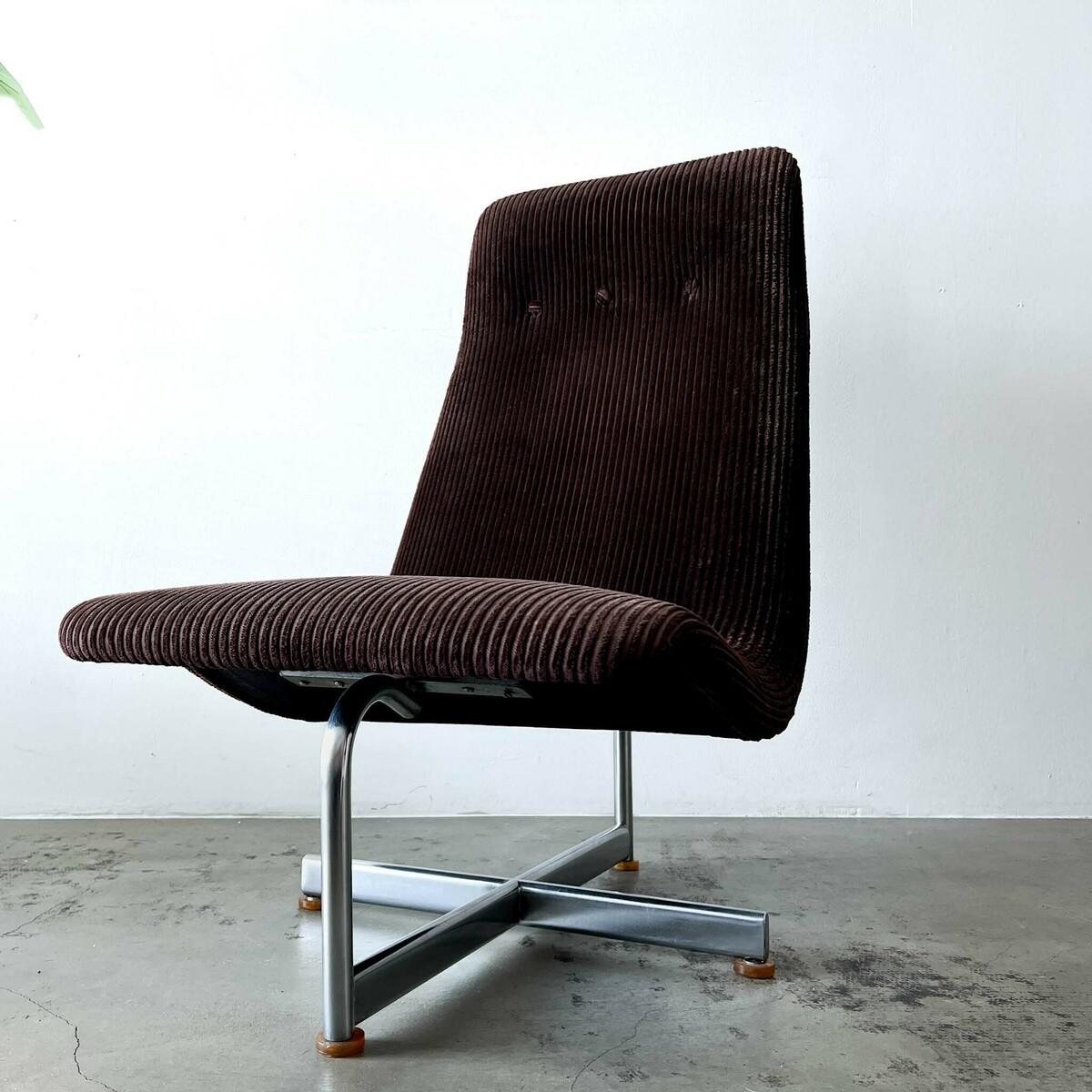 Kho Liang Ie’s *Lounge Chair,* circa 1975, is a rare prototype combining a chrome-plated base with rich brown corduroy upholstery. This minimalist design highlights Kho Liang Ie’s skill in merging sleek industrial materials with warm, tactile