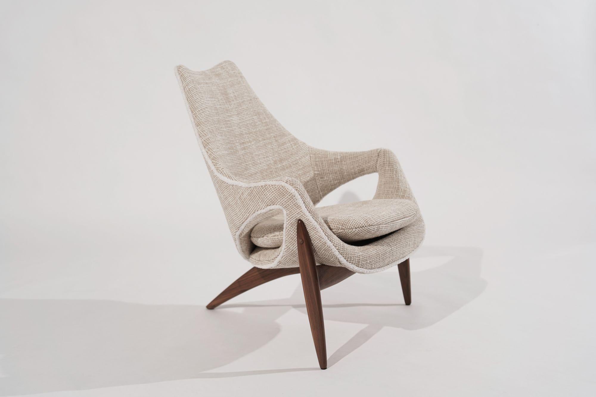 Luigi Tiengo 1950s Sculptural Walnut Lounge Chair, a true vintage gem meticulously restored by Stamford Modern. 
Designed by Luigi Tiengo for Cimon in Montreal, Canada, this lounge chair is a tribute to mid-century modern design. Its sculptural