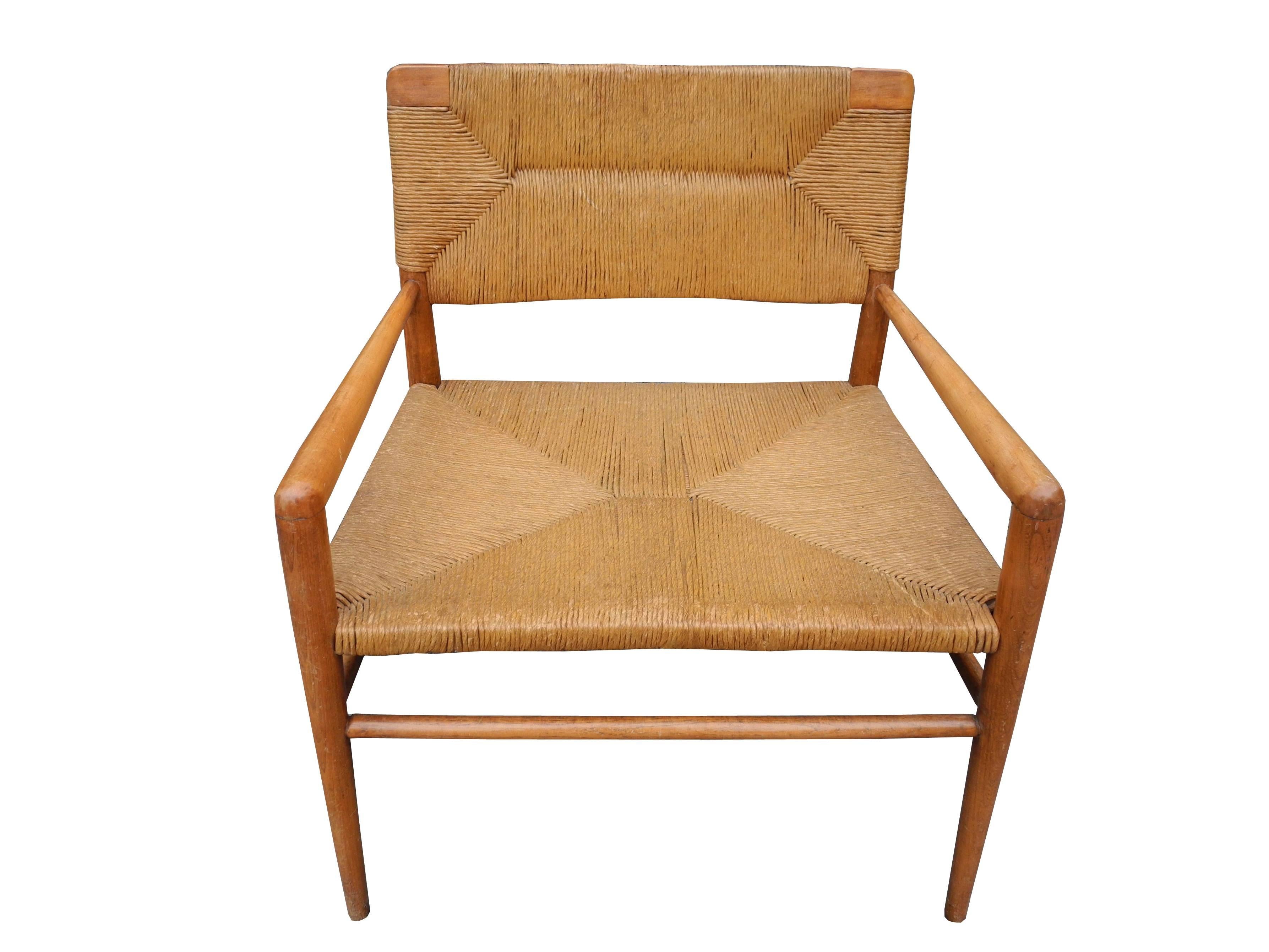 This vintage, comfortable, single, low, lounge chair by Mel Smilow is made of walnut and handwoven rush.