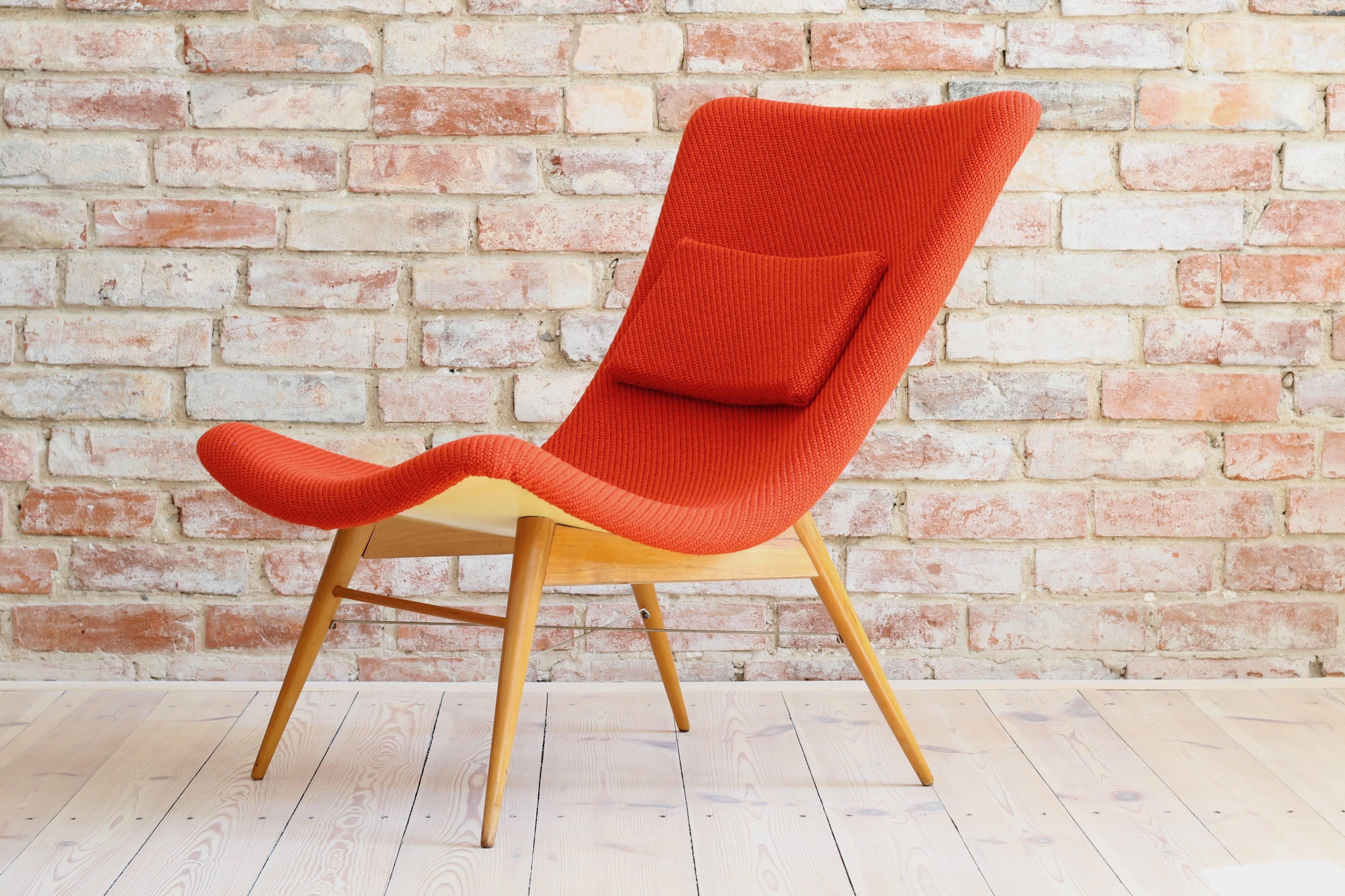 Lounge chair by Miroslav Navratil, manufactured in former Czechoslovakia by Cesky Nabytek, 1959. Original wooden base, fiberglass shell seating. The chair is newly upholstered with a high quality fabric by a Danish brand 