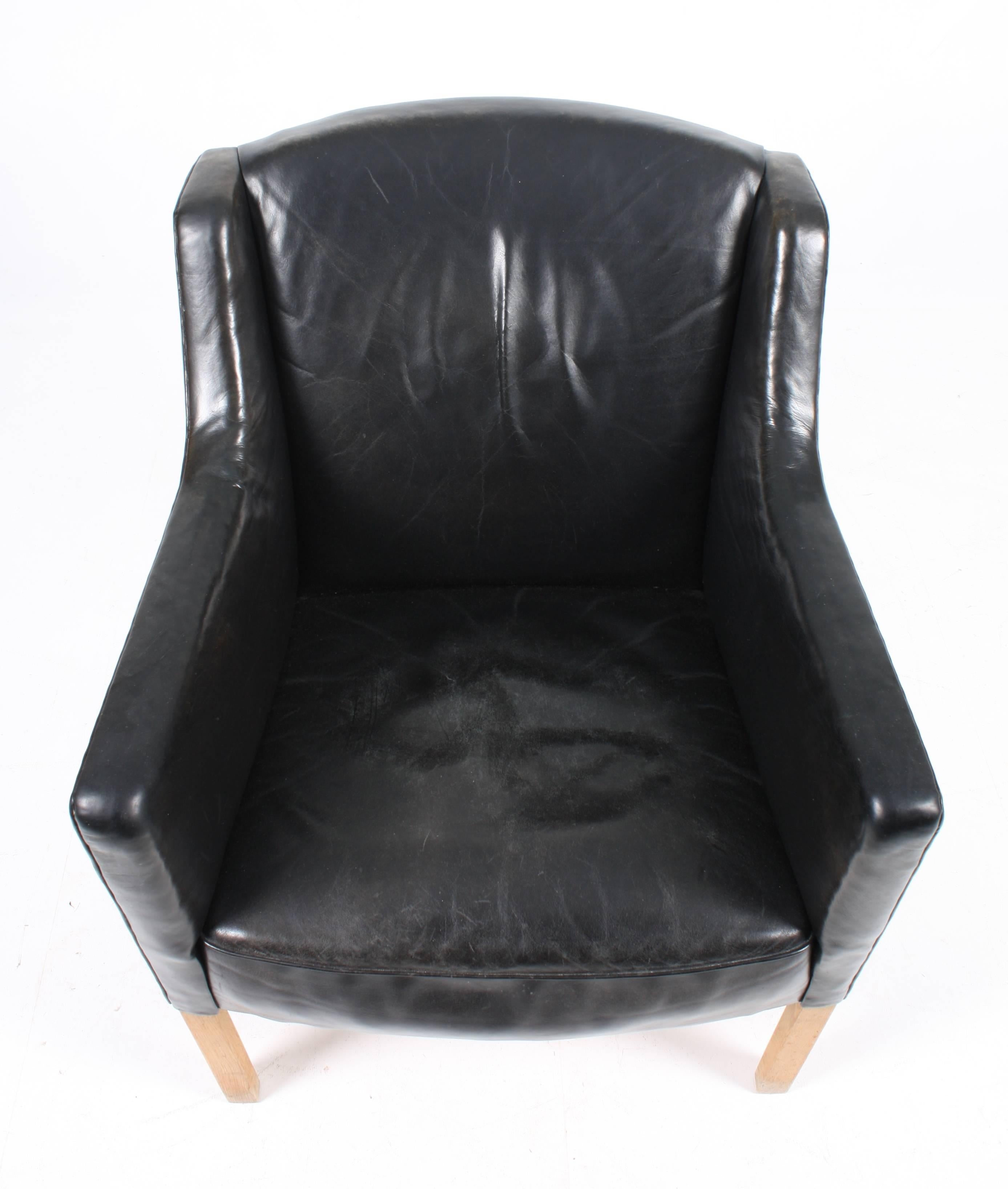 Classic lounge chair in patinated leather designed by Ole Wanschar M.A.A. for A.J. Iversen Cabinetmakers in 1946. Made in Denmark. Great original condition.