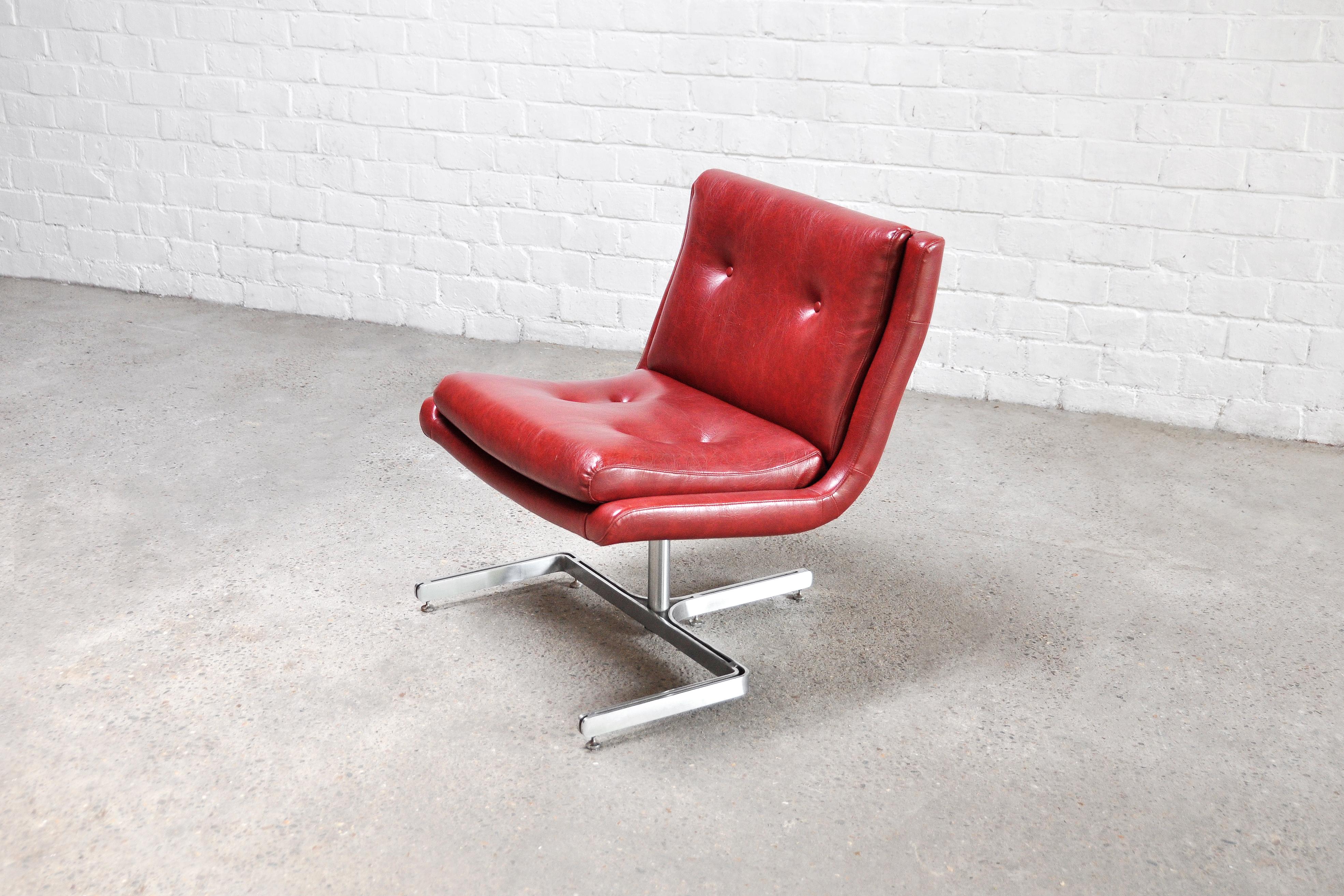 A beautiful lounge chair designed by Raphael Raffel, initially made for the interior of the executive office of the P.T.T. Telecom in France in 1973. This version is upholstered in a warm red eco-leather, and features the typical sculptural